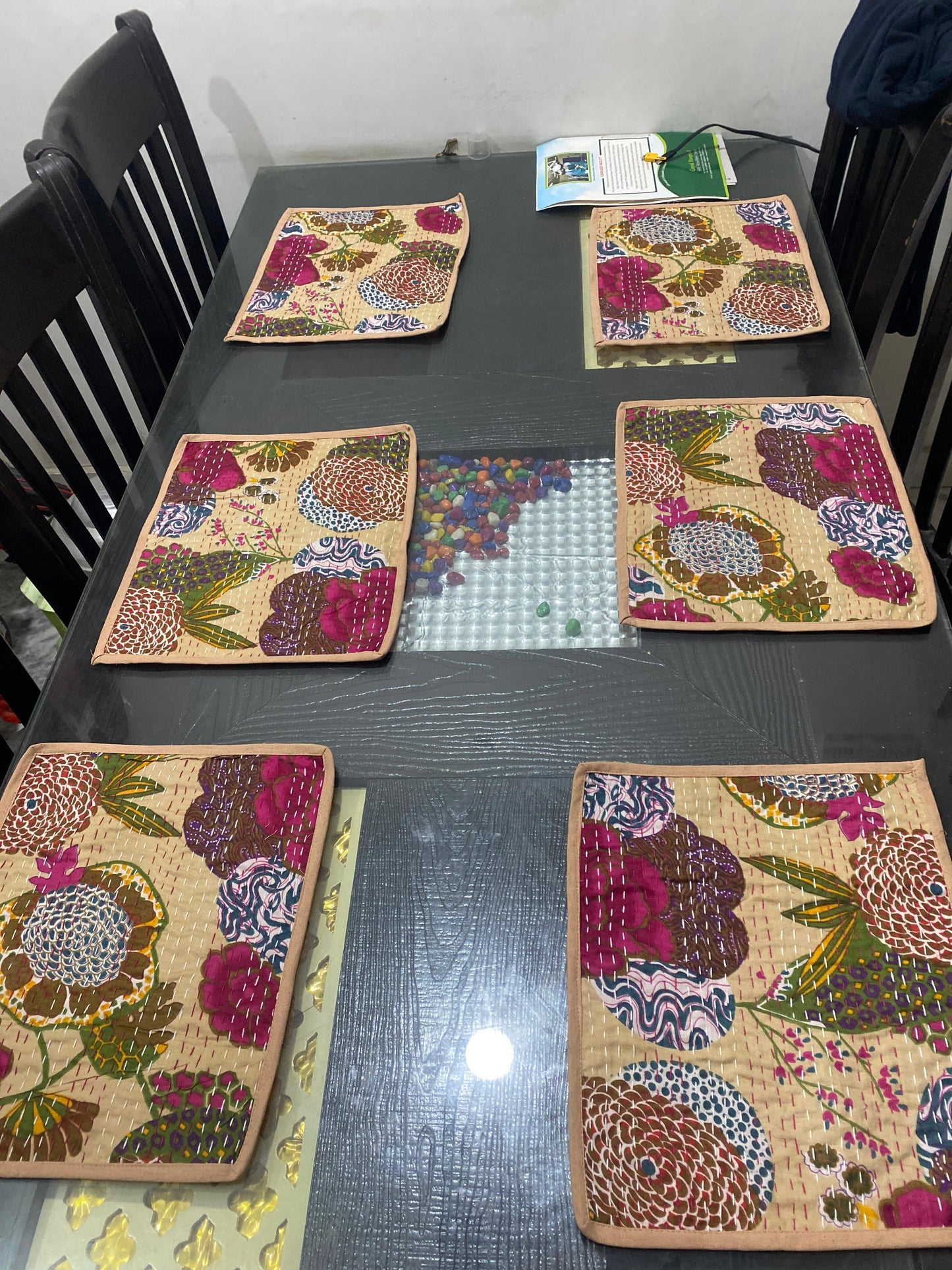 Floral-patterned placemats on a dark table