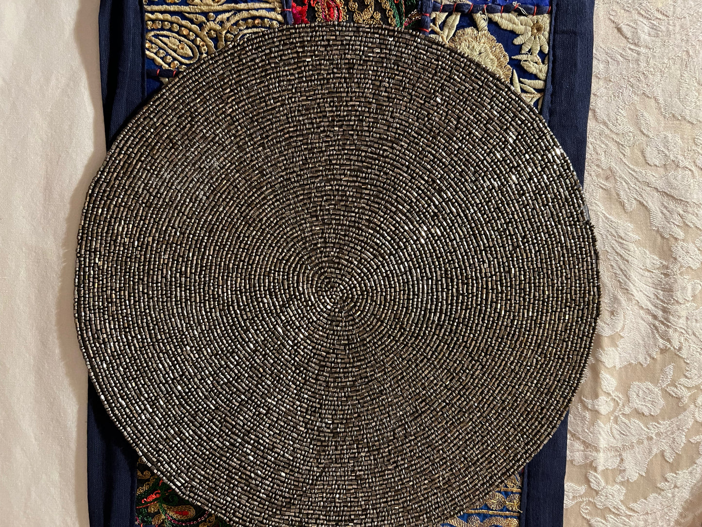 Handcrafted beadwork accent placemats and chargers, featuring intricate designs and vibrant colors, adding a touch of elegance and artistry to your table setting.
