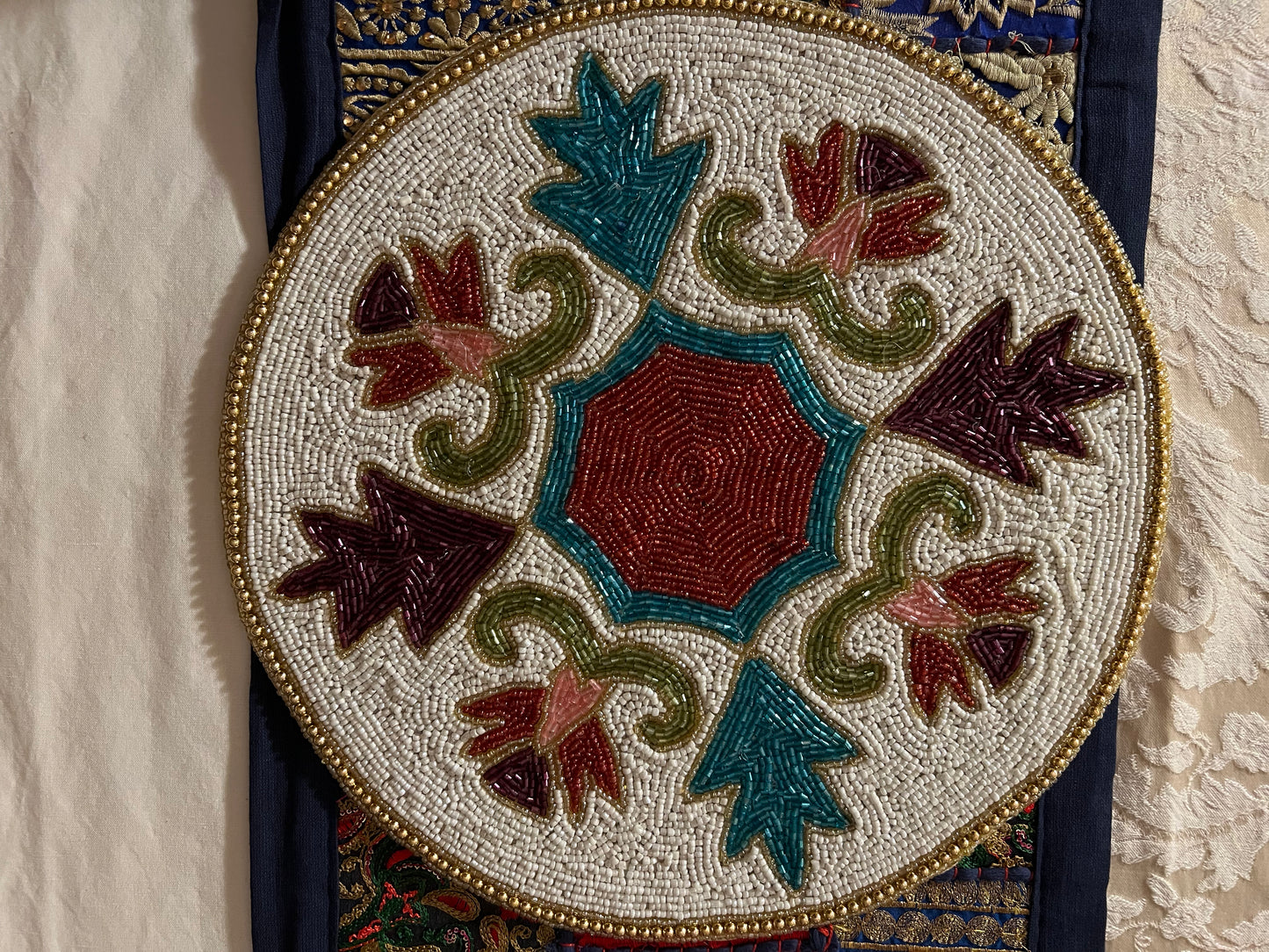 Handcrafted beadwork accent placemats and chargers, featuring intricate designs and vibrant colors, adding a touch of elegance and artistry to your table setting.