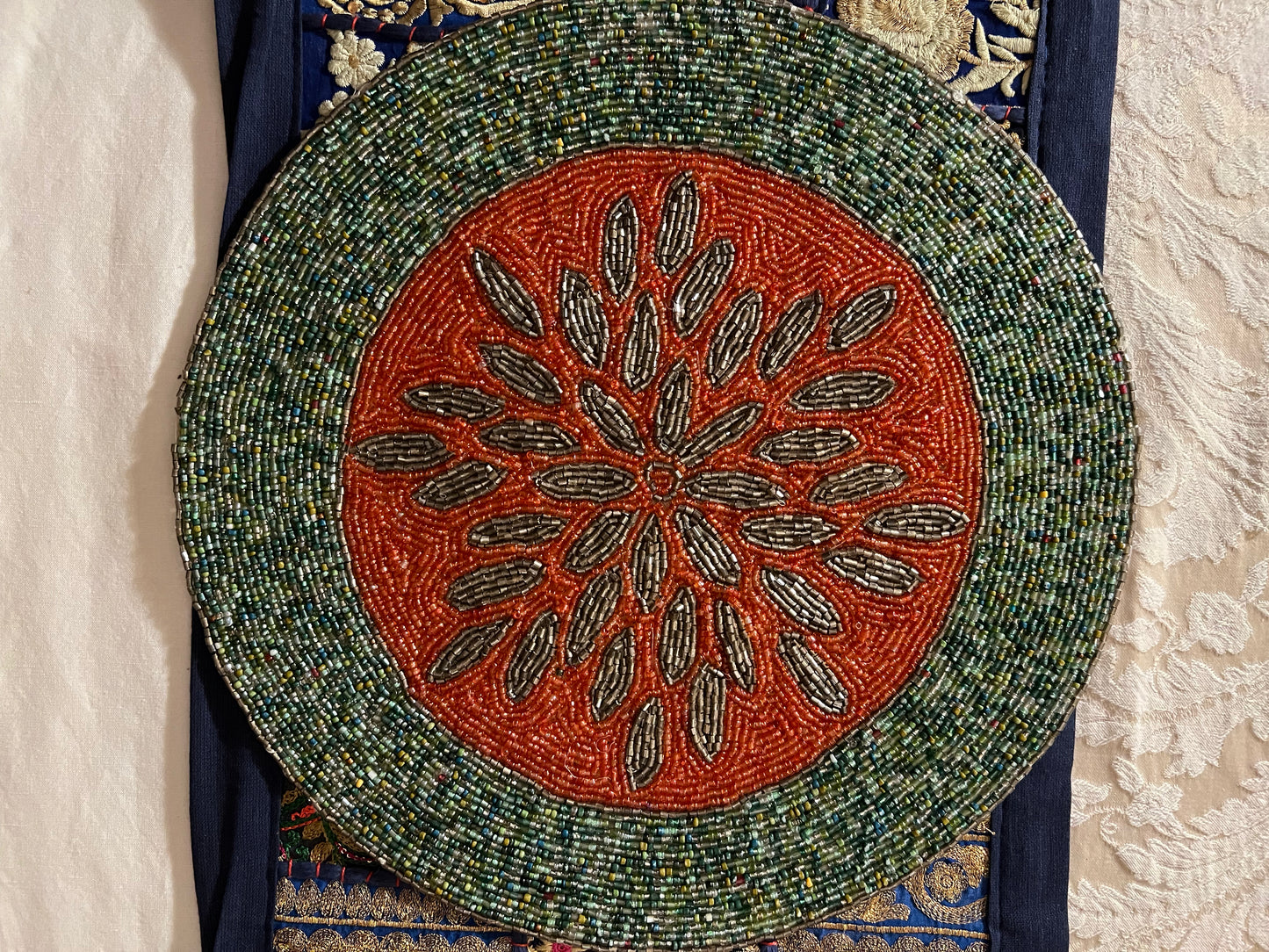 Handcrafted beadwork accent placemats and chargers, featuring intricate designs and vibrant colors, adding a touch of elegance and artistry to your table setting.