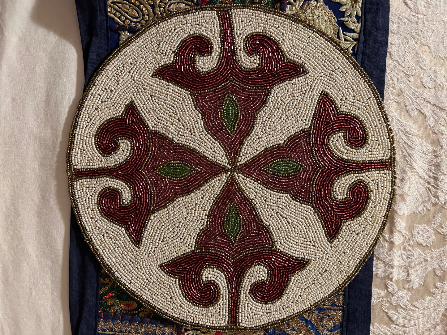 Handcrafted beadwork accent placemats and chargers, featuring intricate designs and vibrant colors, adding a touch of elegance and artistry to your table setting.