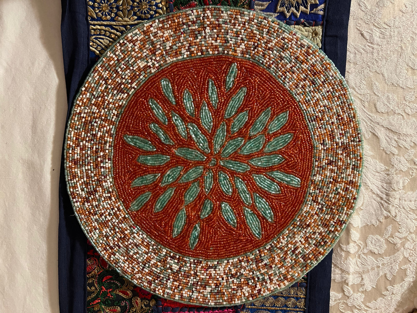 Handcrafted beadwork accent placemats and chargers, featuring intricate designs and vibrant colors, adding a touch of elegance and artistry to your table setting.