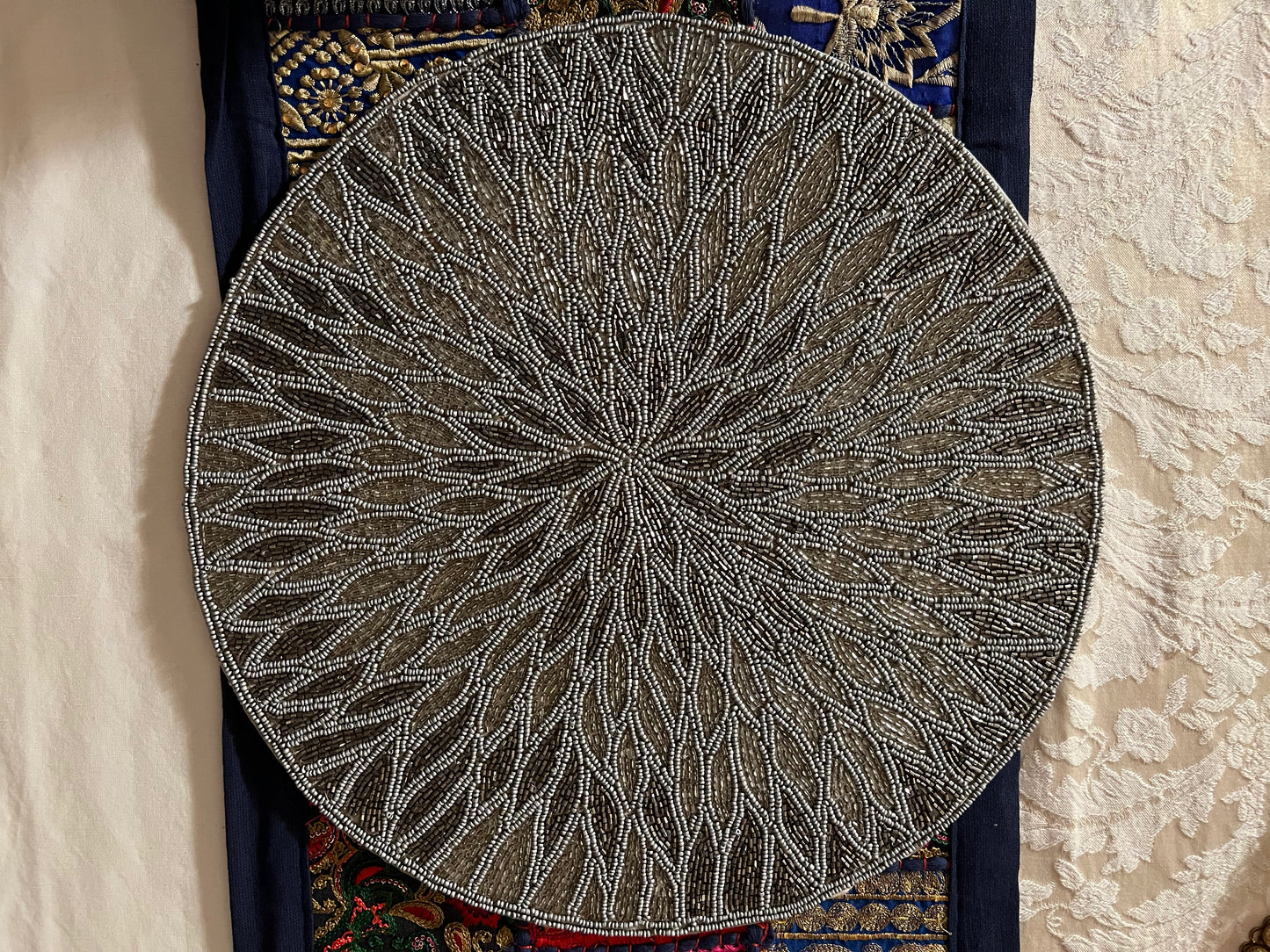 Handcrafted beadwork accent placemats and chargers, featuring intricate designs and vibrant colors, adding a touch of elegance and artistry to your table setting.