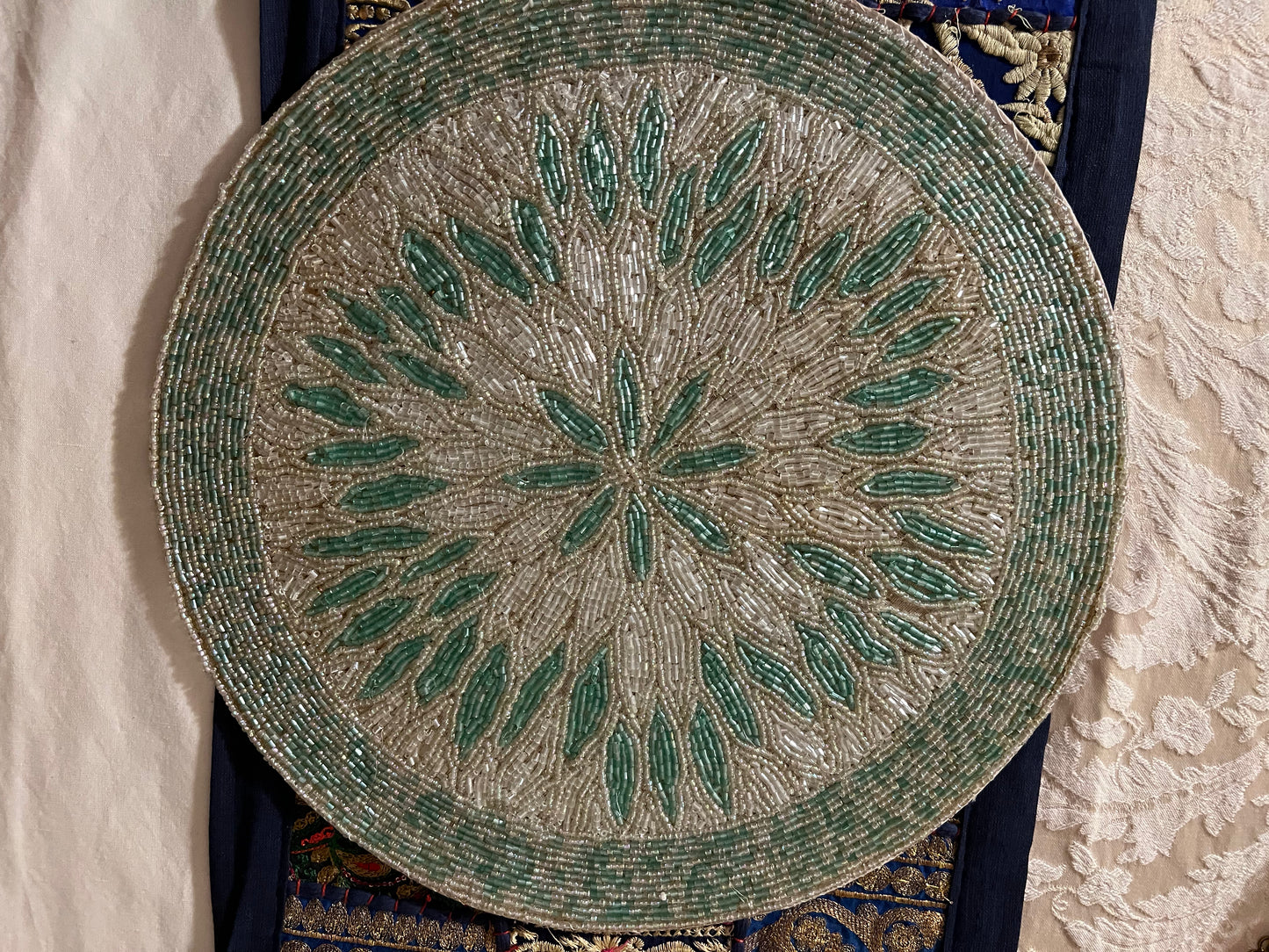Handcrafted beadwork accent placemats and chargers, featuring intricate designs and vibrant colors, adding a touch of elegance and artistry to your table setting.