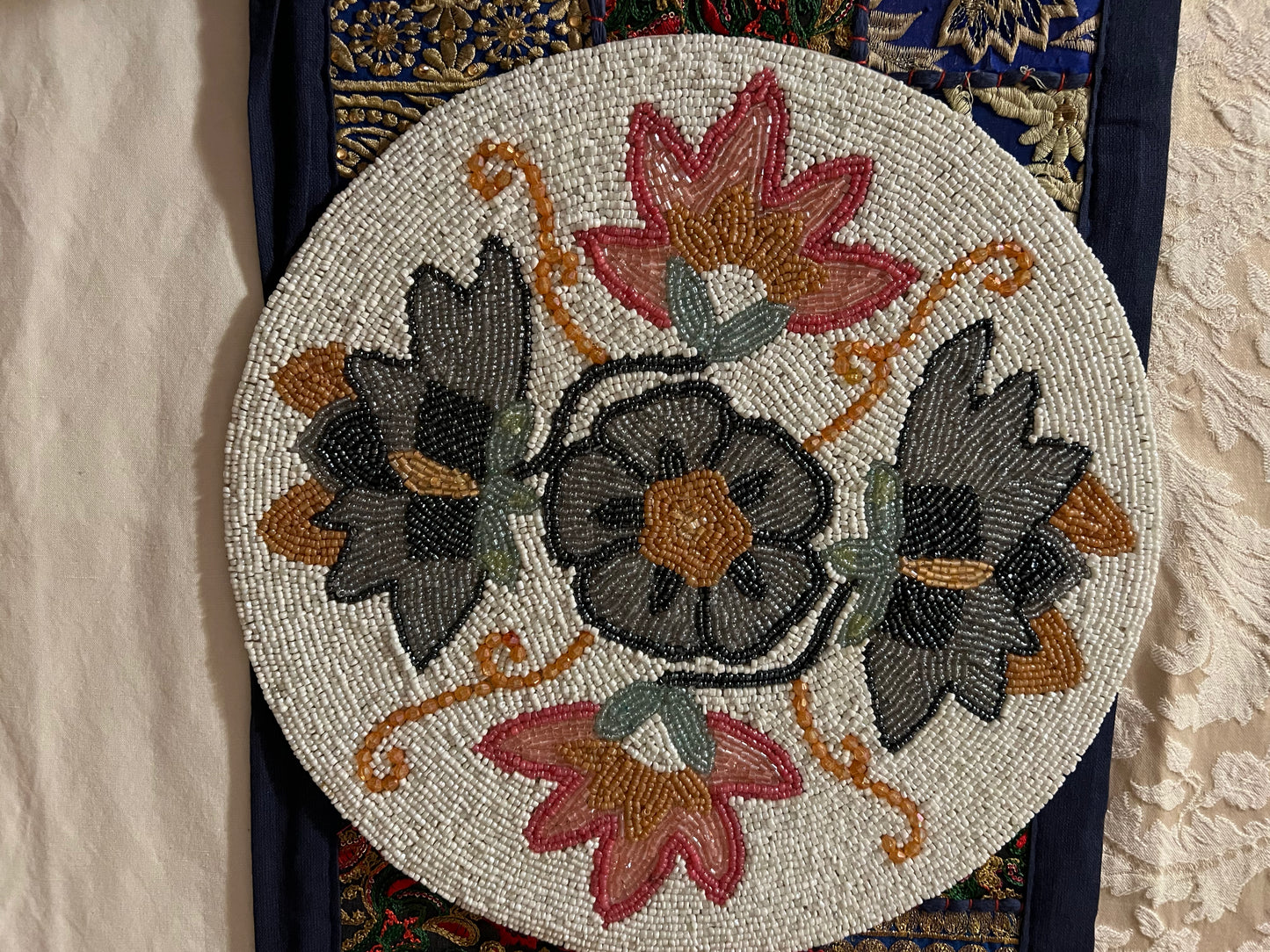Handcrafted beadwork accent placemats and chargers, featuring intricate designs and vibrant colors, adding a touch of elegance and artistry to your table setting.