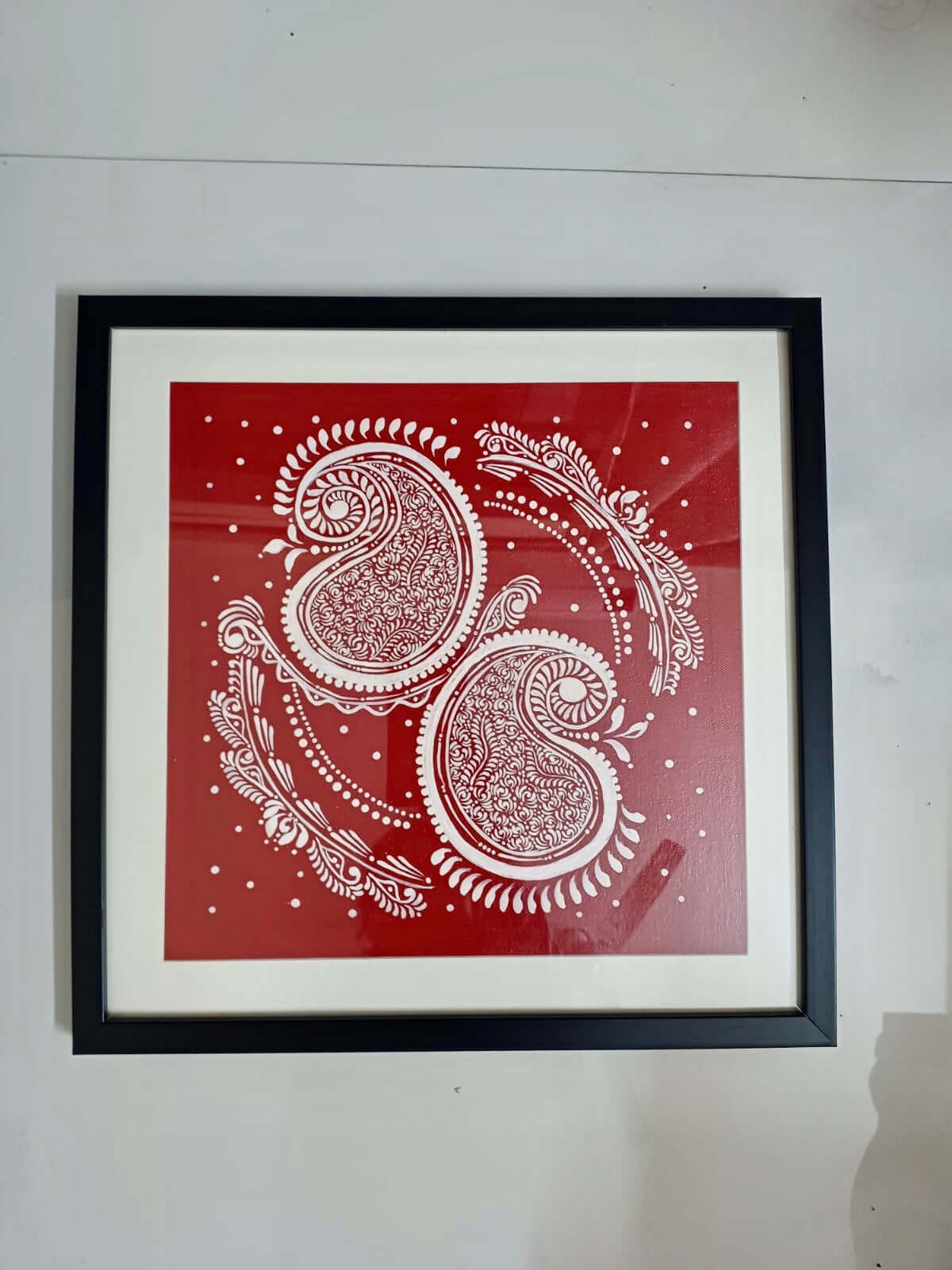 Handcrafted Alpona art wall decor featuring intricate, traditional Bengali motifs in elegant, flowing patterns.
