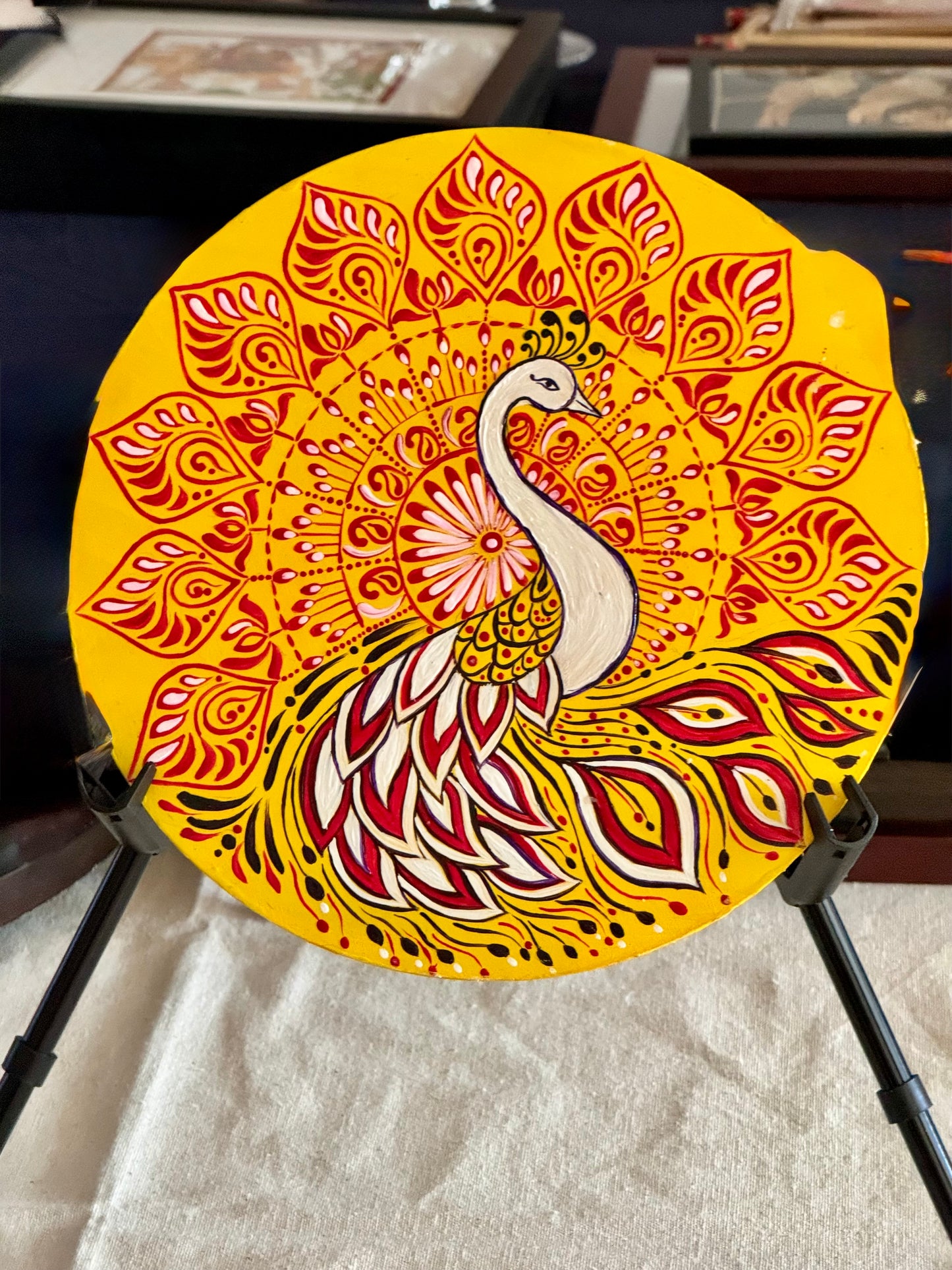 Hand-painted Alpona wall decor plate featuring intricate traditional motifs inspired by Bengali folk art. A stunning blend of cultural heritage and craftsmanship to elevate your home decor.