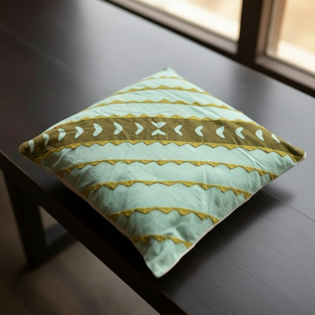 Decorative pillow with green and yellow pattern on a dark surface
