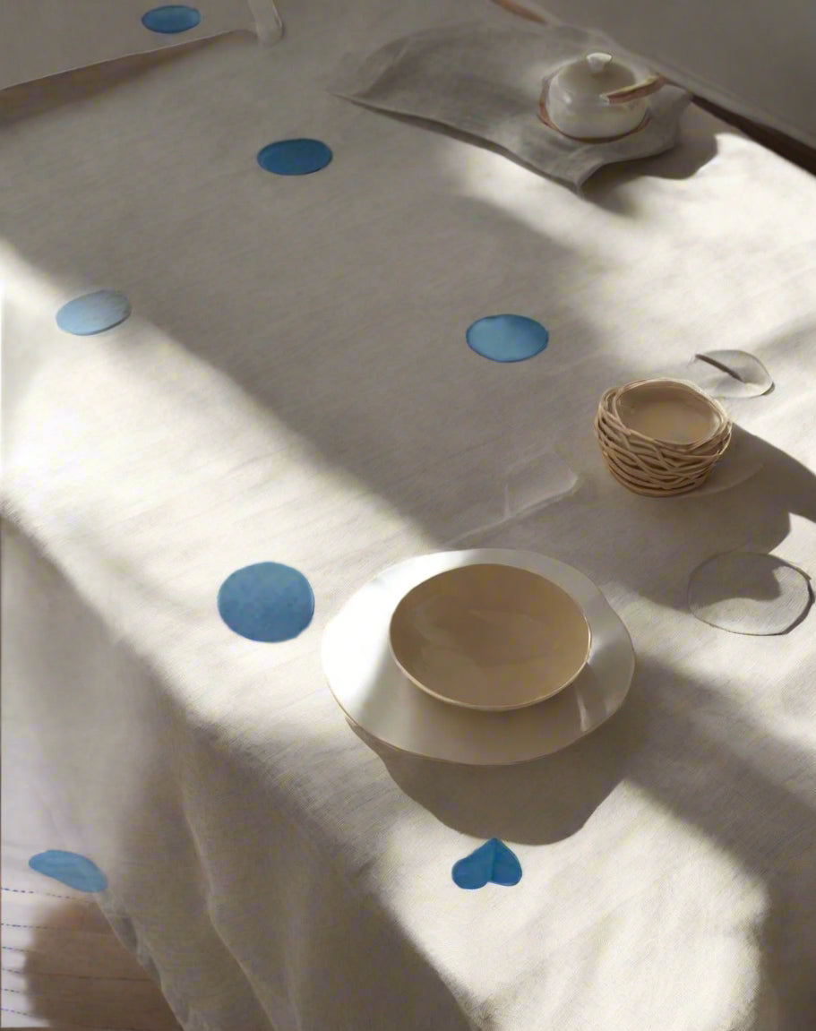 White tablecloth with blue polka dots in appliqué work