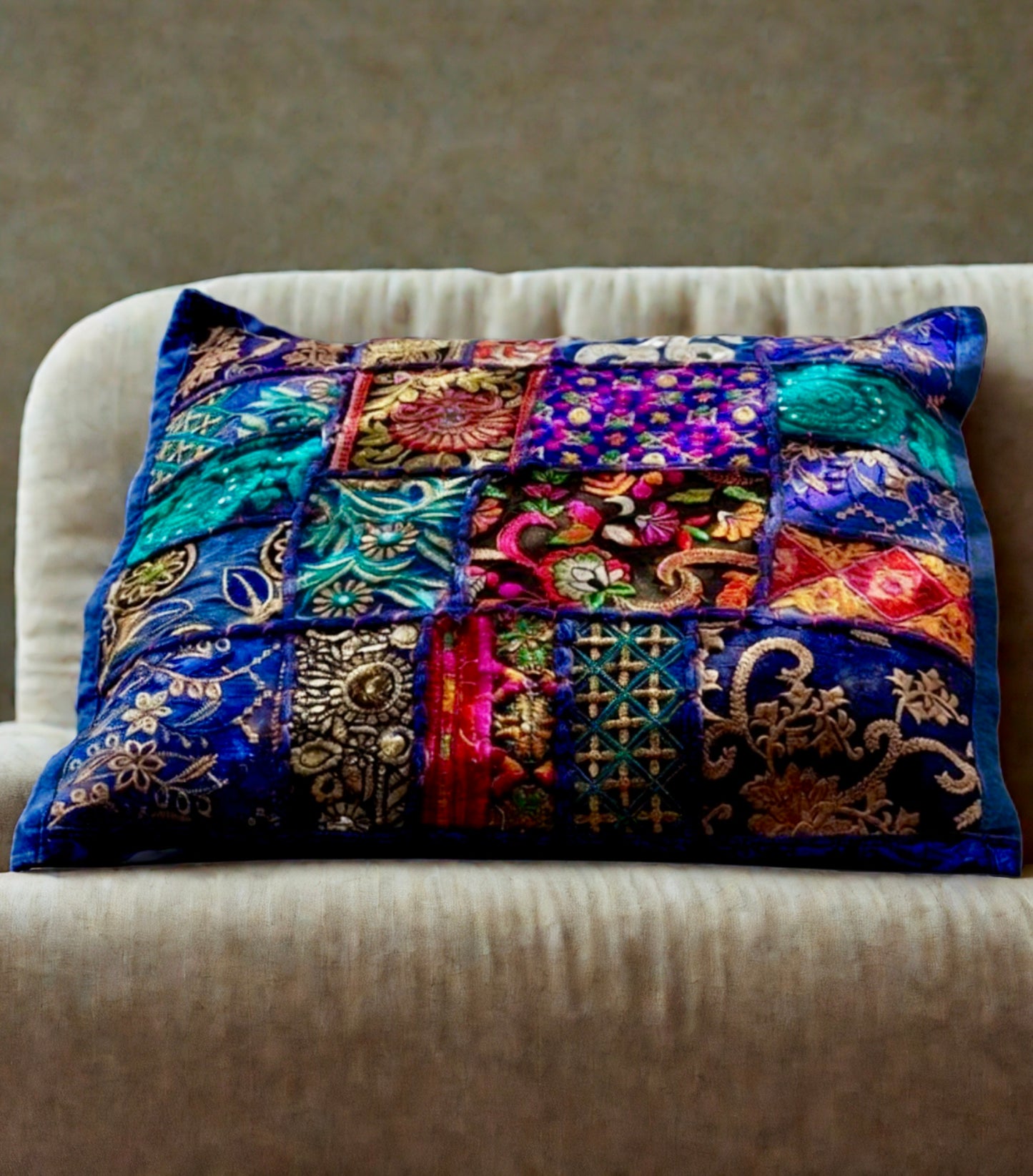 Cushion cover crafted from Khambhadia patchwork, showcasing a collage of vintage fabrics, intricate embroidery, and mirror accents in bold, vibrant colors.