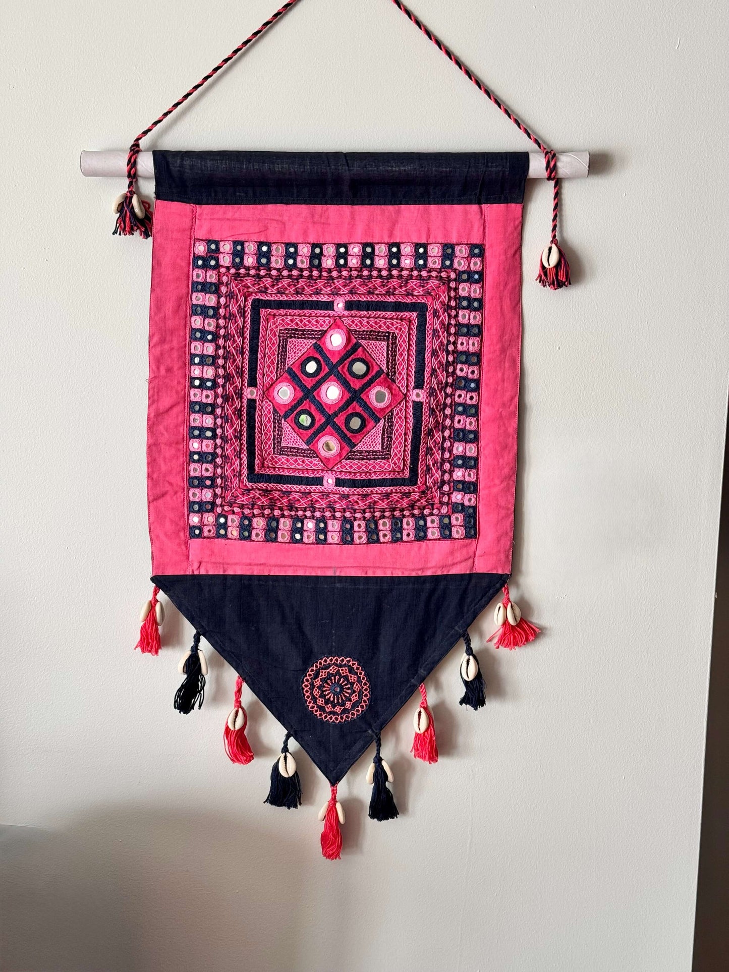 Handcrafted Lambani work textile wall decor, featuring intricate embroidery, mirror work, and vibrant patterns. A stunning display of traditional craftsmanship, adding cultural richness and texture to your space.