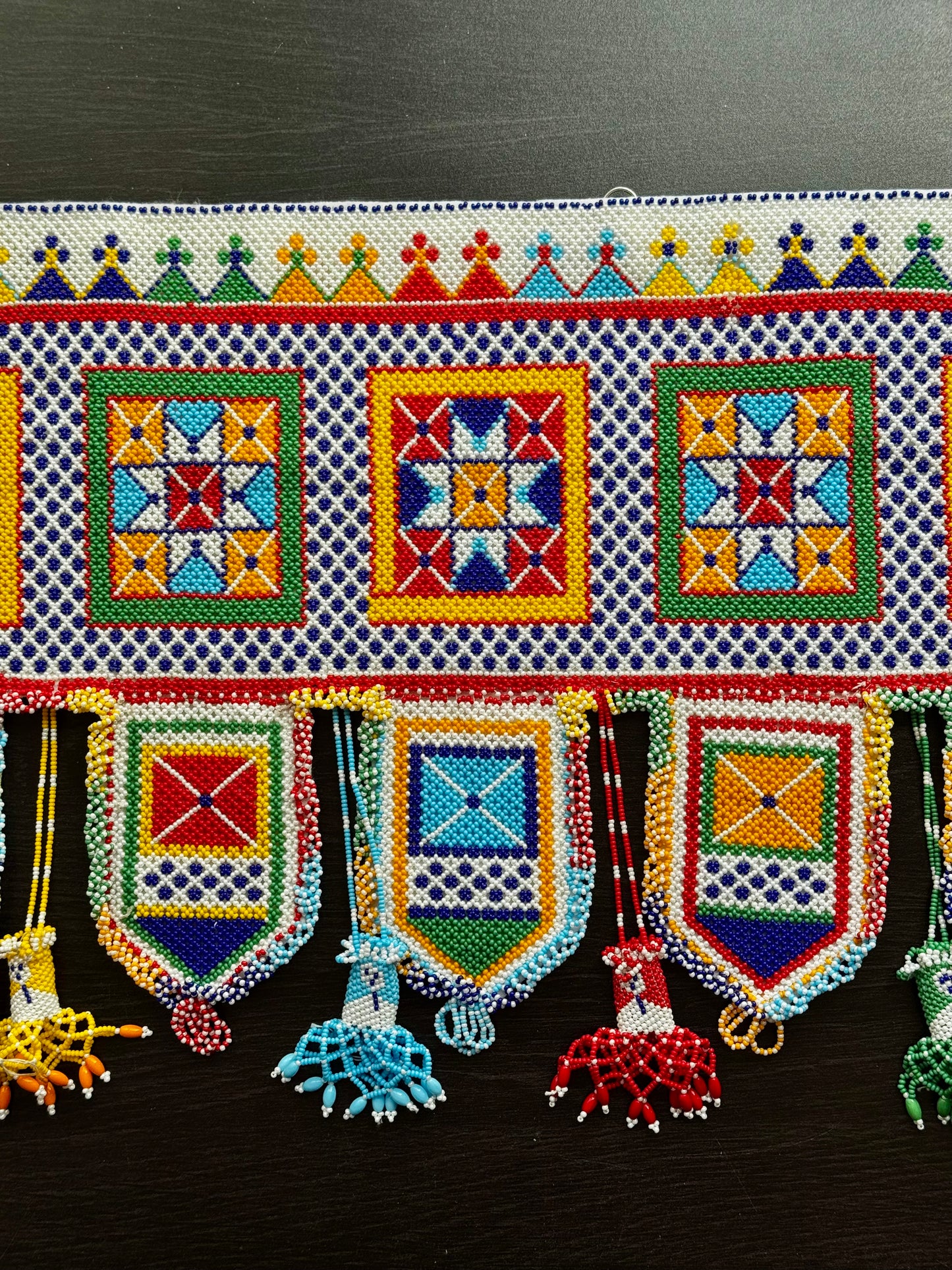 Colorful Motikaam design close up with geometric patterns on a dark background