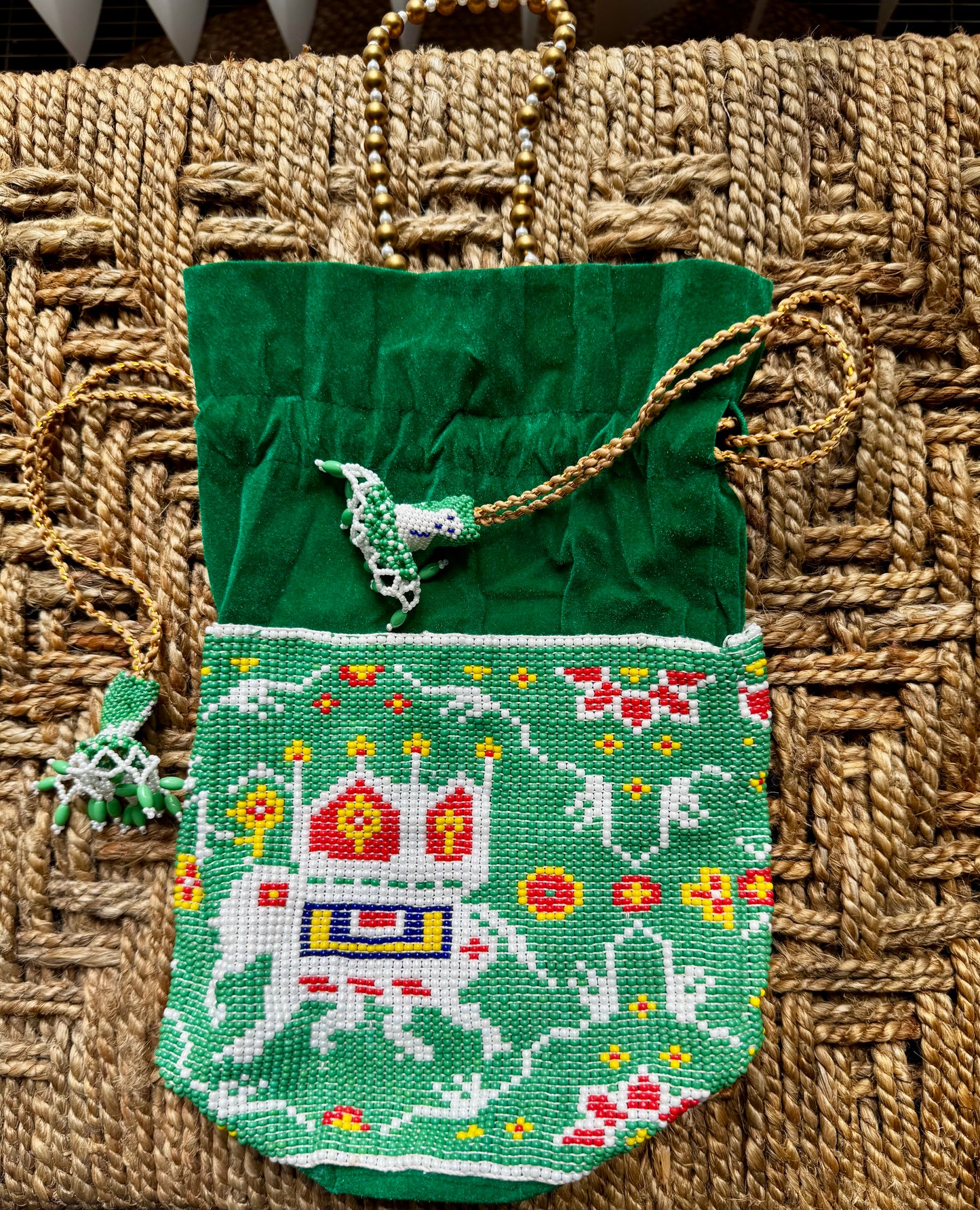 Green Pearl embroidered pouch with a horse design on a woven surface
