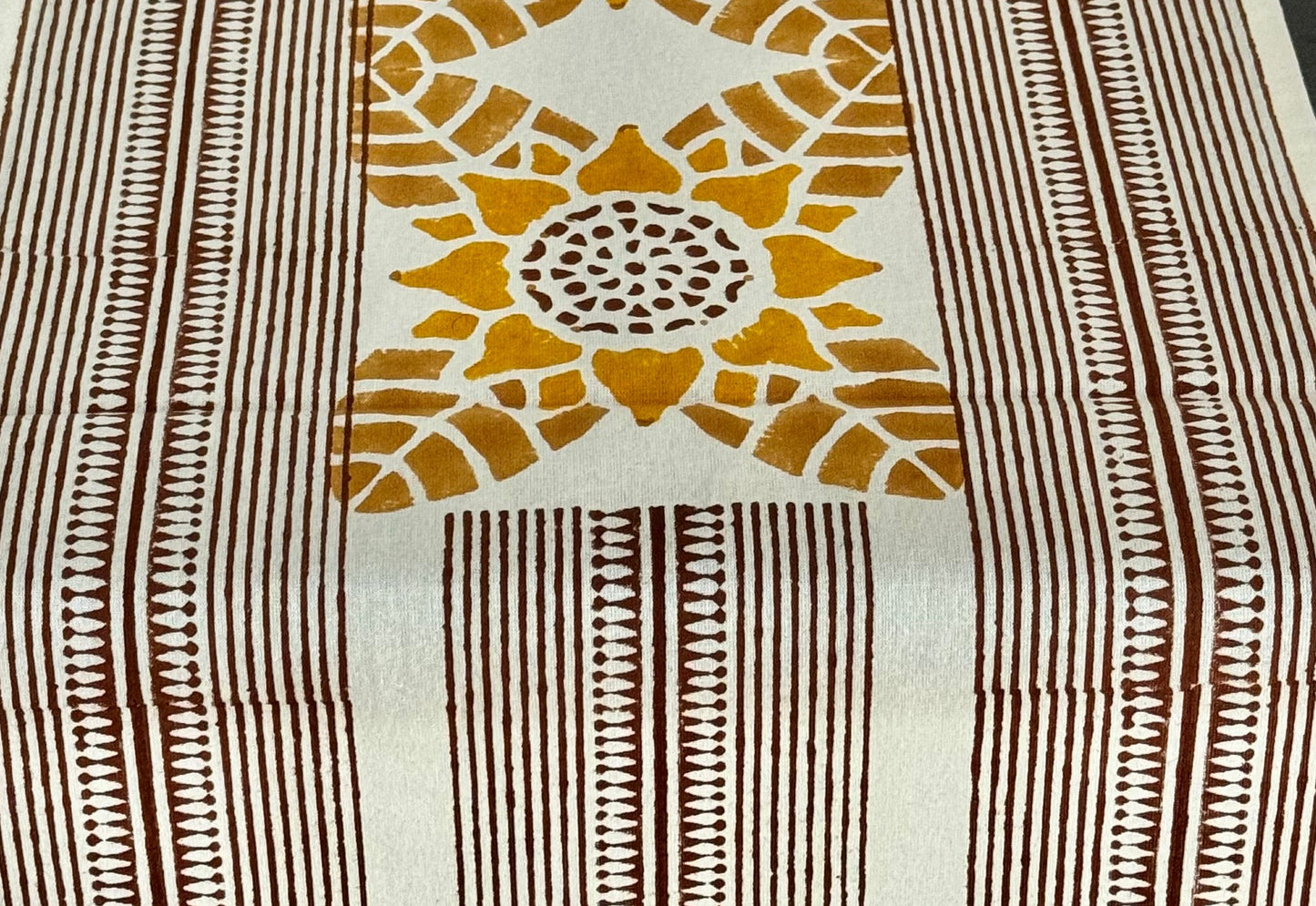 Decorative table runner with geometric pattern on a wooden table