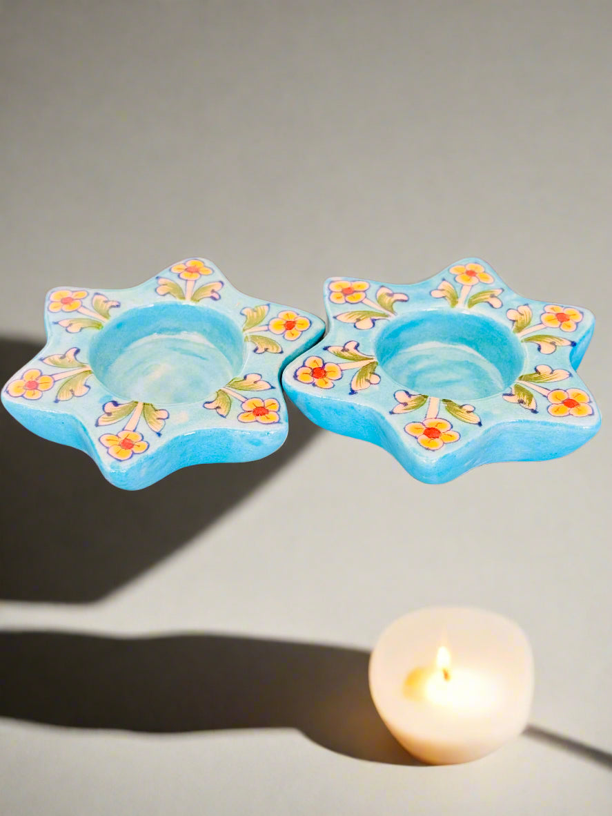 Handcrafted Jaipur Blue Pottery tea light holders, featuring intricate designs and vibrant blue hues, adding a traditional Indian touch to your home decor.