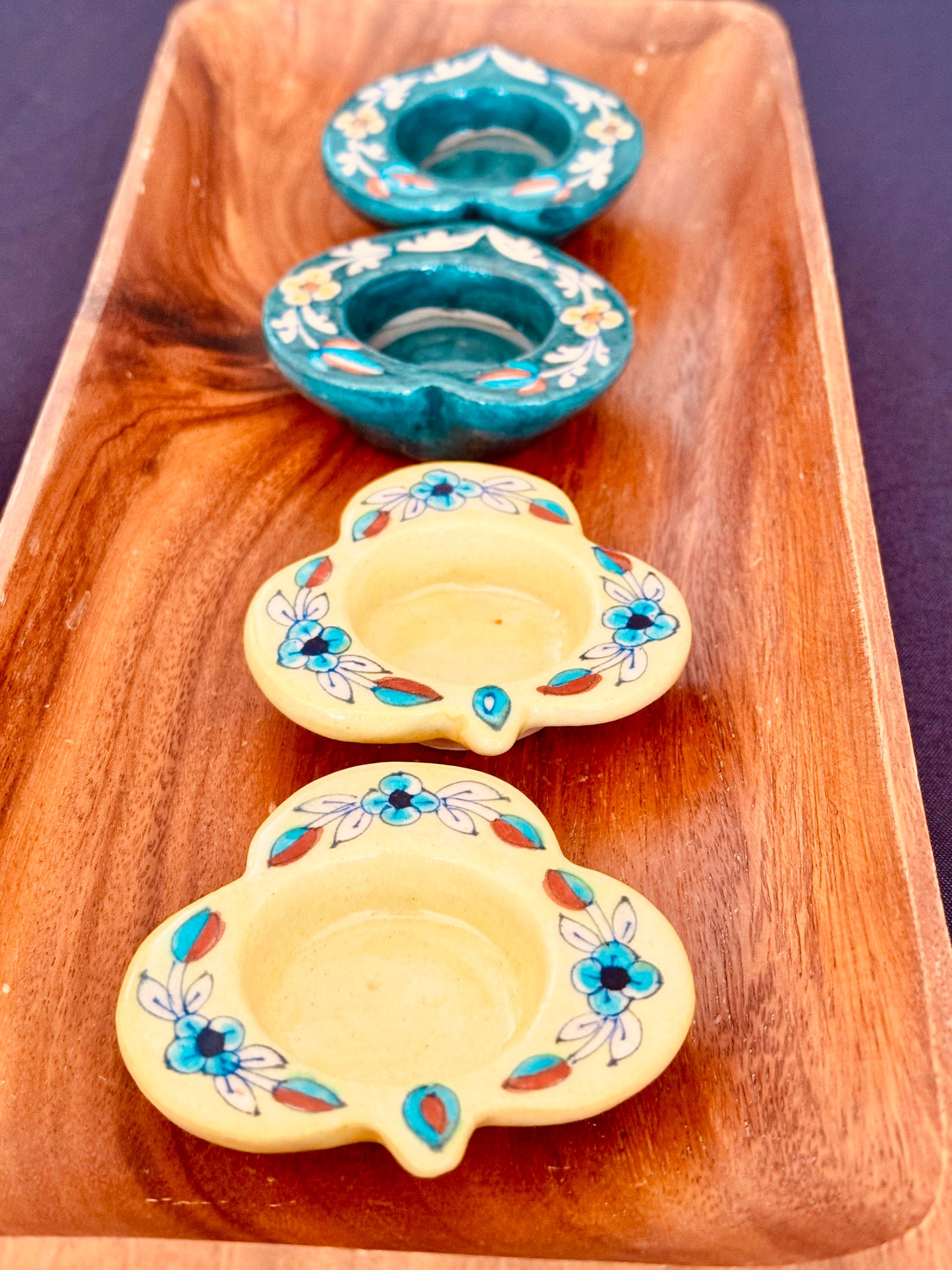 Handcrafted Jaipur Blue Pottery tea light holders, featuring intricate designs and vibrant blue hues, adding a traditional Indian touch to your home decor.