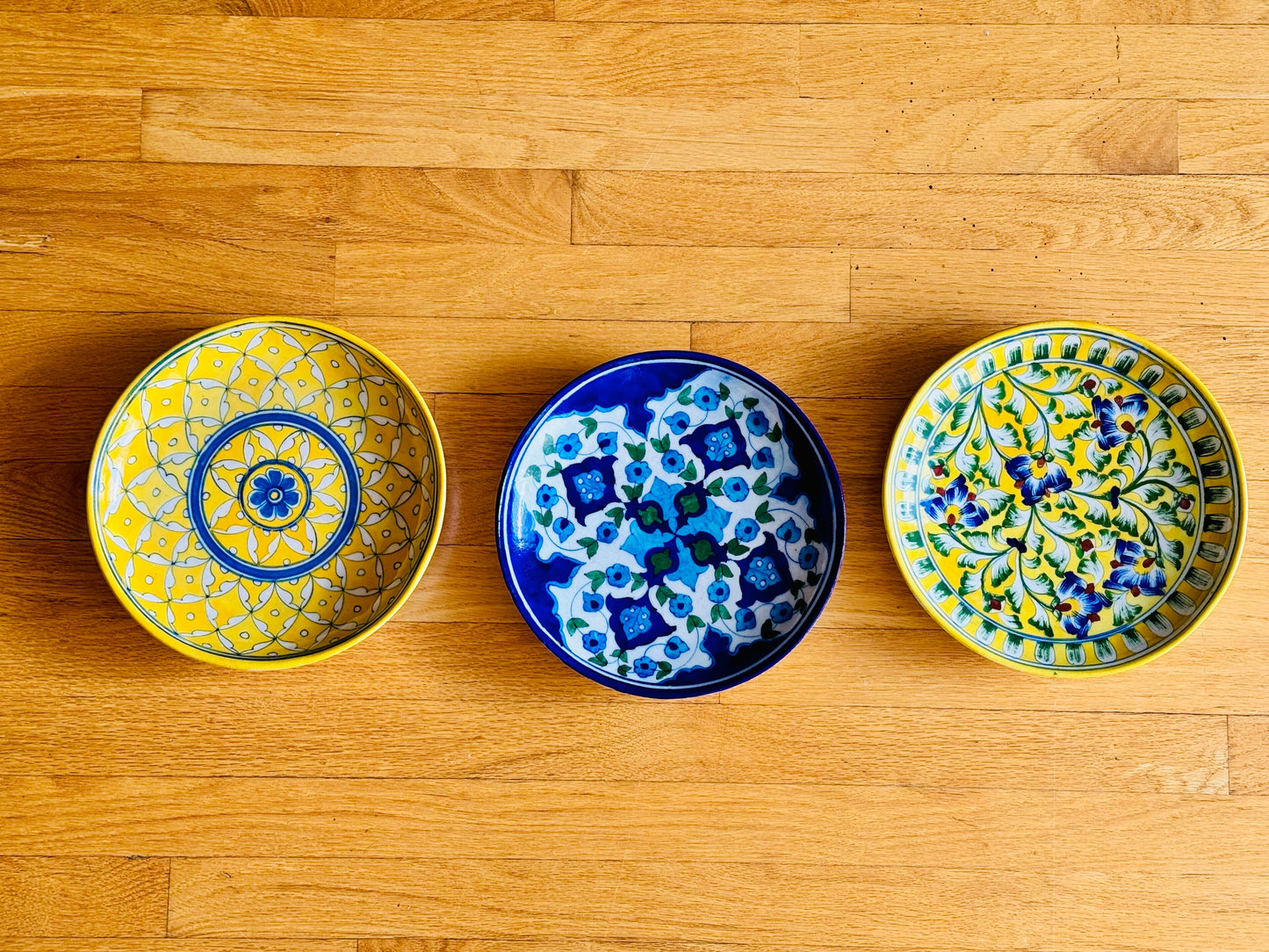 Handcrafted Jaipur Blue Pottery plates, beautifully decorated with intricate patterns and vibrant colors, perfect for adding a touch of traditional Indian art to your wall decor.