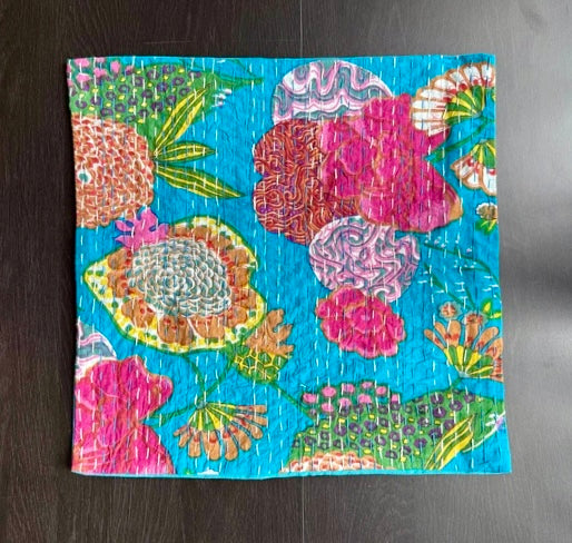 Colorful floral patterned fabric on a dark surface