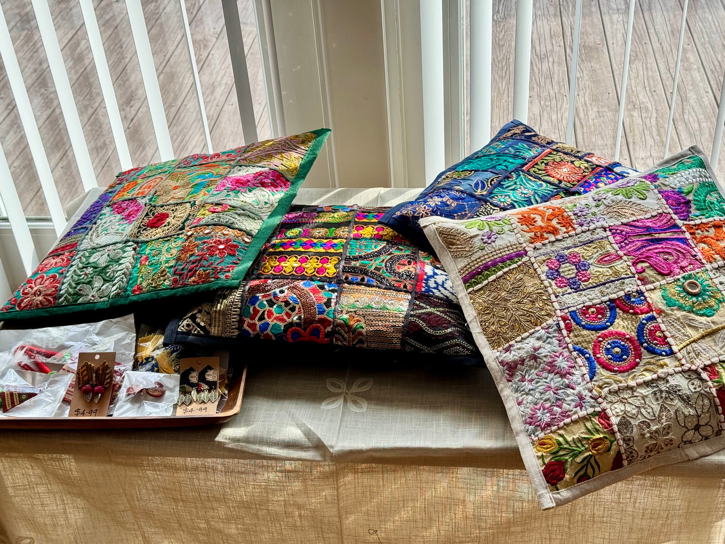 Cushion cover crafted from Khambhadia patchwork, showcasing a collage of vintage fabrics, intricate embroidery, and mirror accents in bold, vibrant colors.