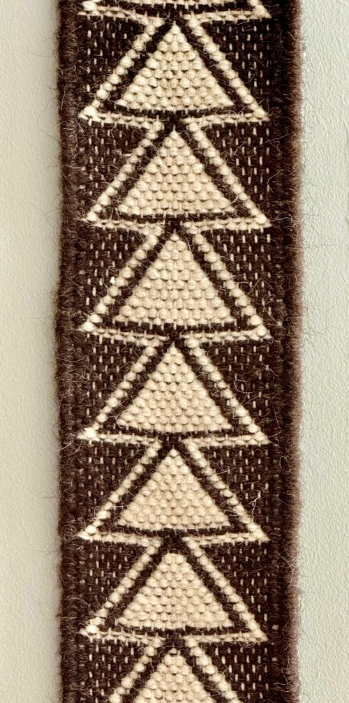 Kutchi Kharad totem rug strip with geometric triangle pattern on a plain background