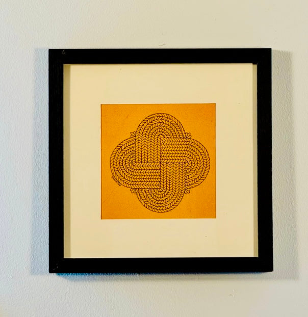 Framed artwork with a geometric design on a yellow background