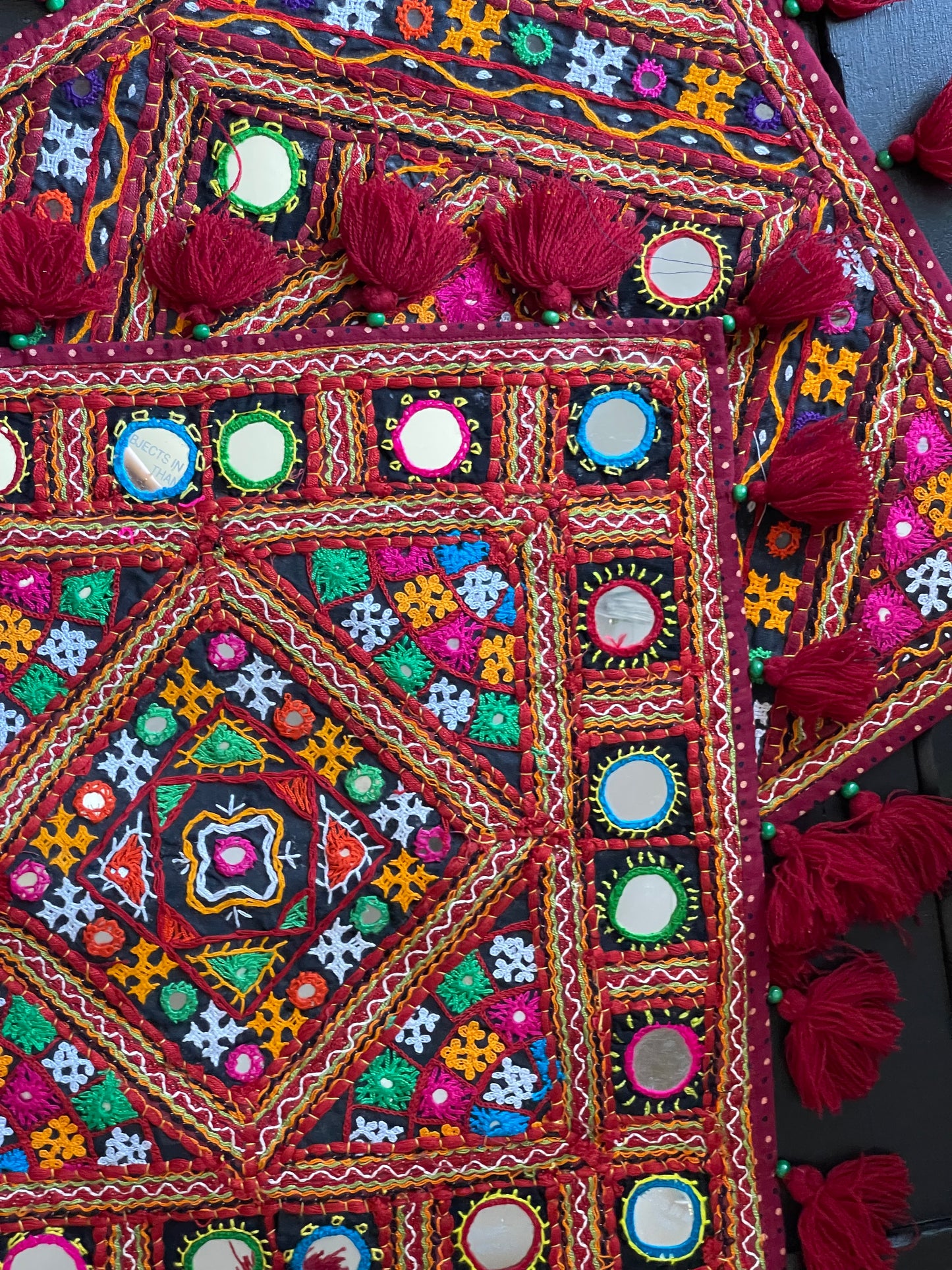 Handcrafted Kutchi embroidery work cushion covers, showcasing vibrant patterns and intricate stitching, reflecting traditional Indian artistry and craftsmanship.