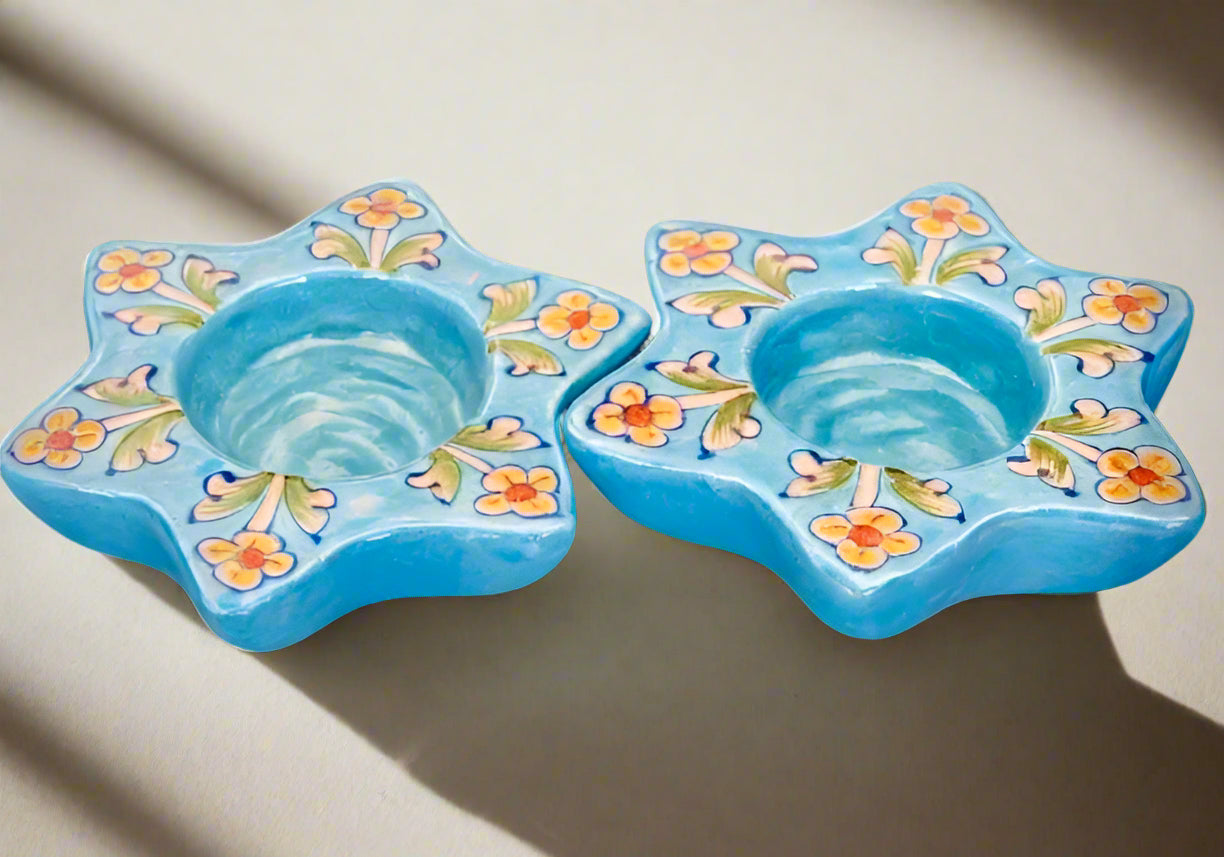 Handcrafted Jaipur Blue Pottery tea light holders, featuring intricate designs and vibrant blue hues, adding a traditional Indian touch to your home decor.