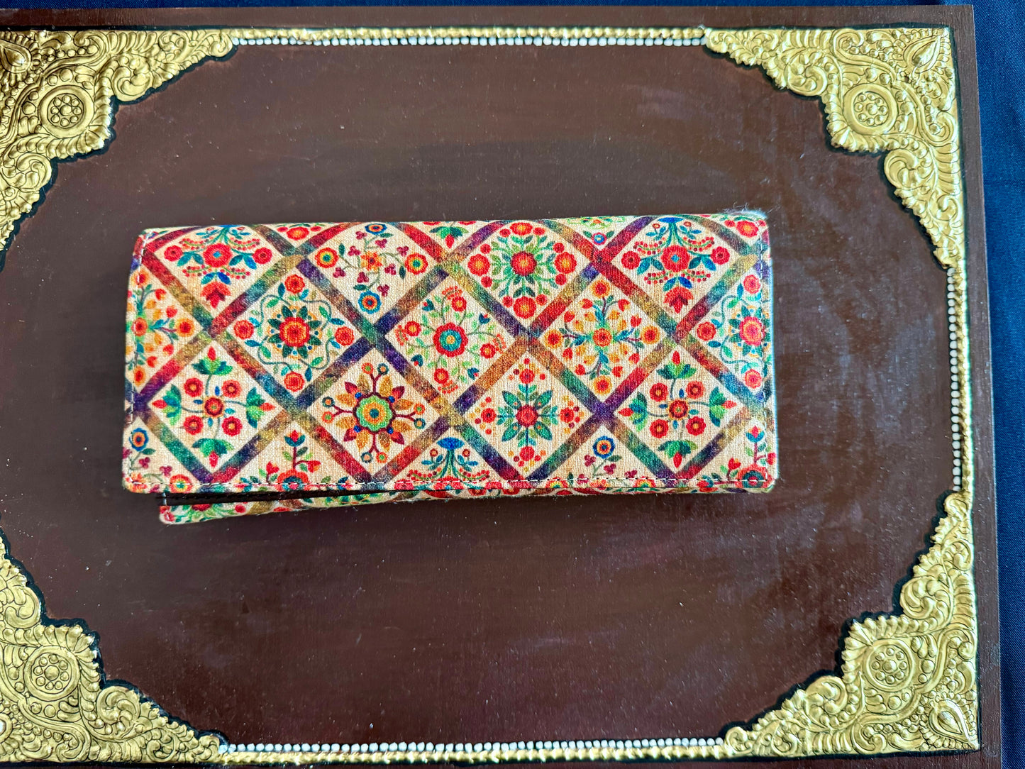 Eco-friendly upcycled fabric wallets with magnetic closure, featuring vibrant patterns and durable stitching, combining sustainability with style.