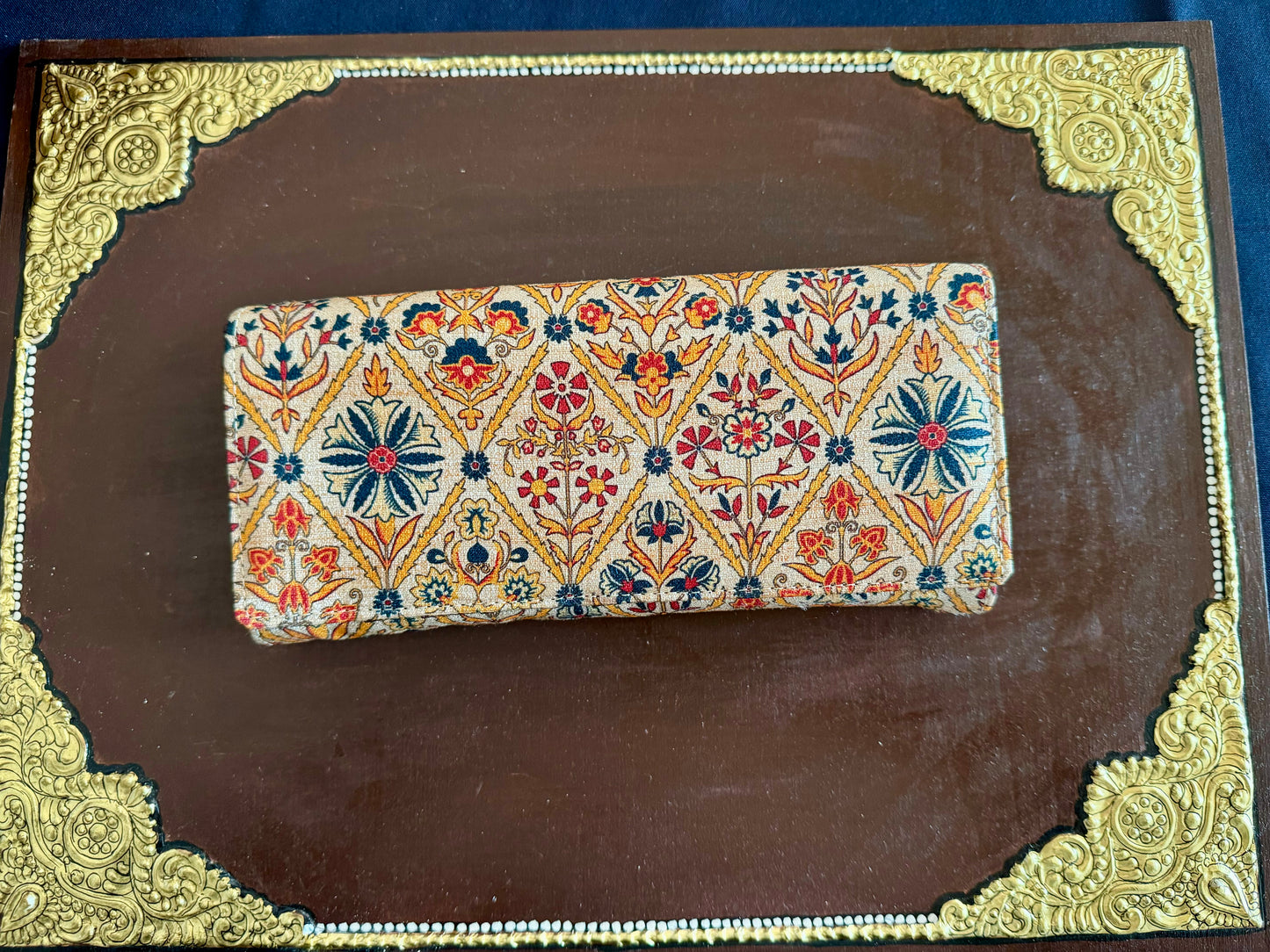 Eco-friendly upcycled fabric wallets with magnetic closure, featuring vibrant patterns and durable stitching, combining sustainability with style.