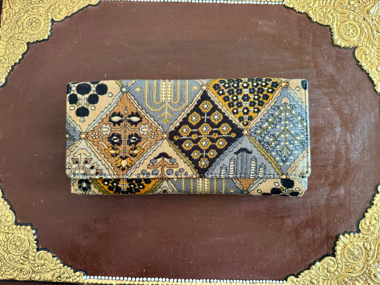 Eco-friendly upcycled fabric wallets with magnetic closure, featuring vibrant patterns and durable stitching, combining sustainability with style.