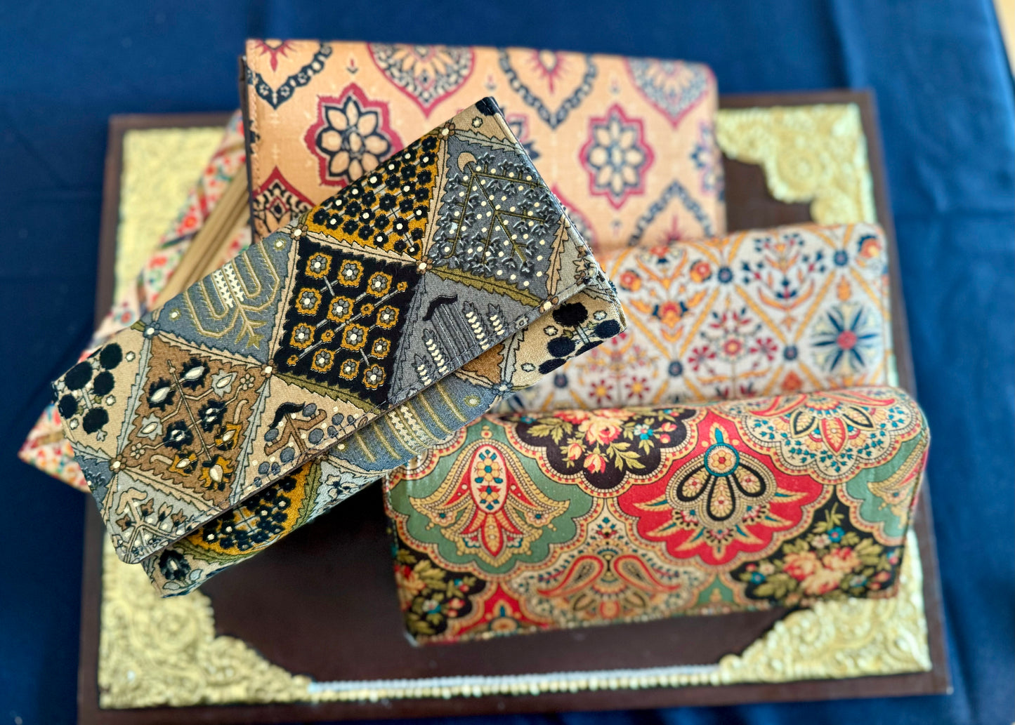 Eco-friendly upcycled fabric wallets with magnetic closure, featuring vibrant patterns and durable stitching, combining sustainability with style.