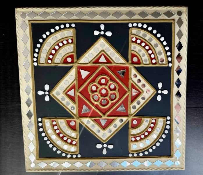 Decorative mosaicLippankaam art piece with geometric pattern on a dark background