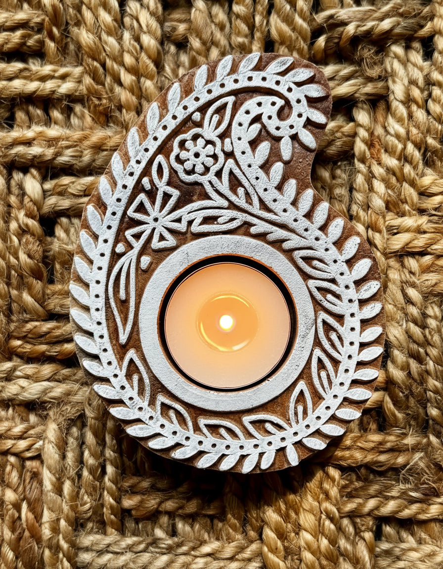Hand engraved Wooden block tea light holder on a textured brown fabric background
