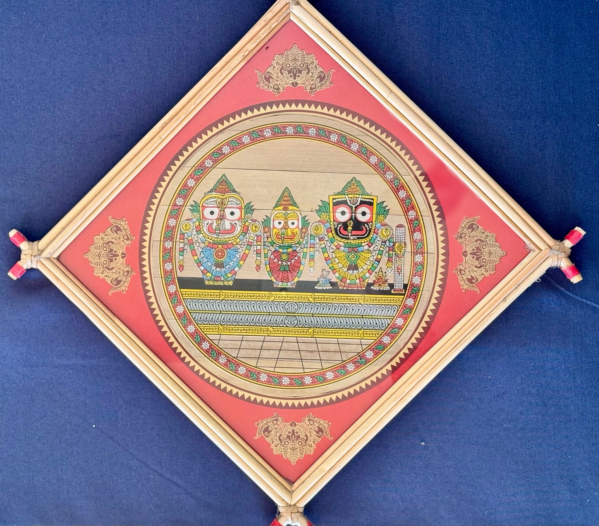 Hand-painted Pattachitra art featuring traditional motifs and mythological stories, elegantly framed with unique bamboo detailing.