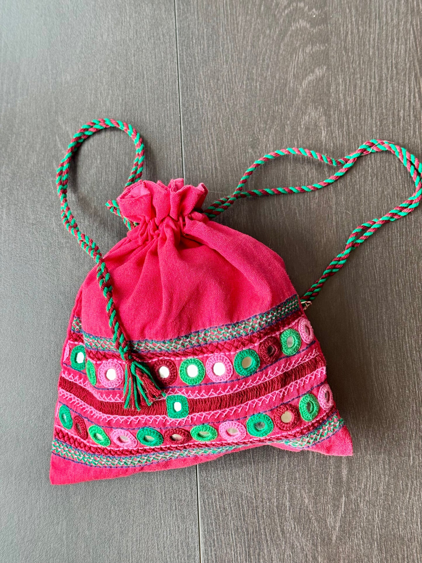 Pink potli bag with intricate Lambani embroidery work