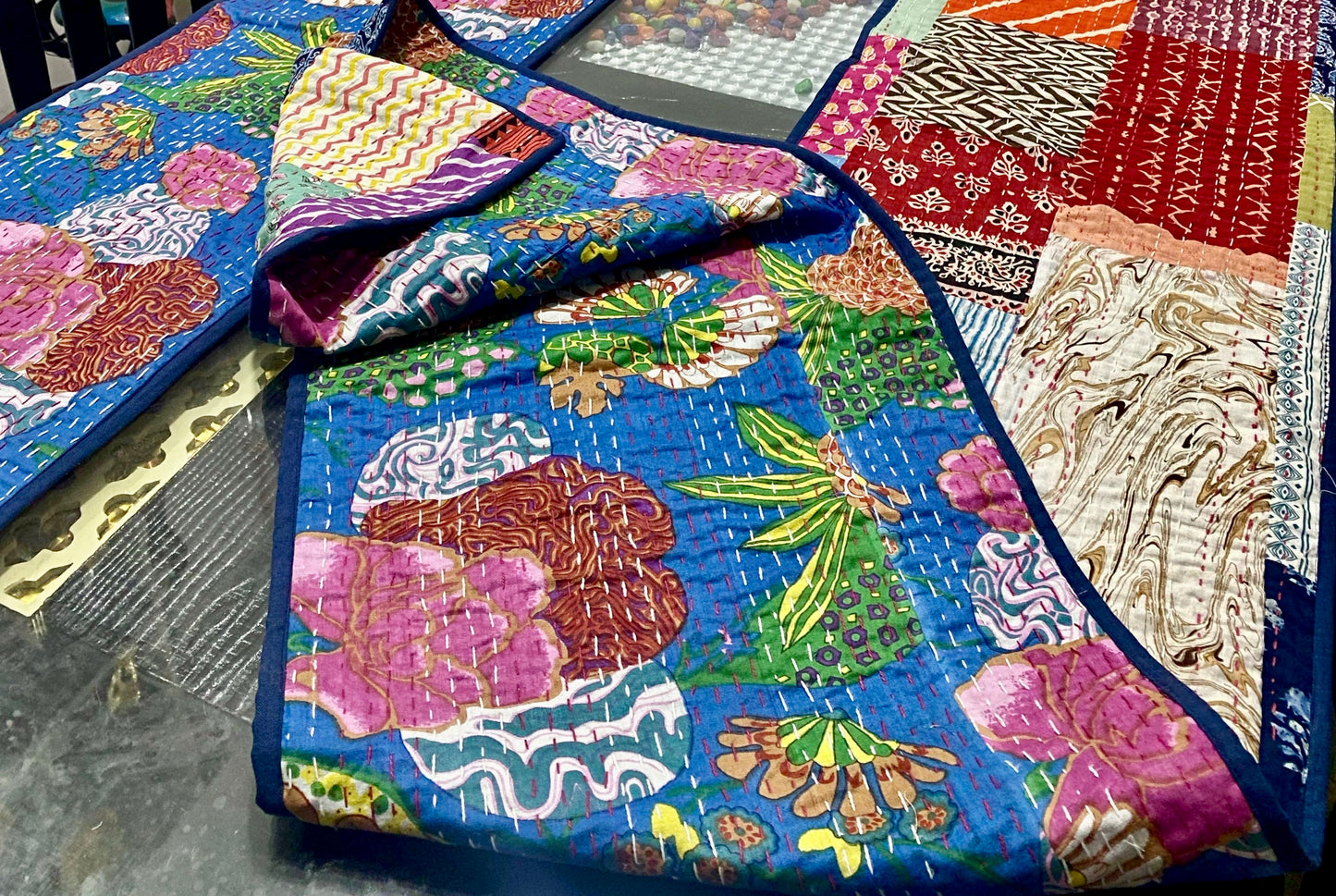 Colorful Kantha table runner with floral patterns on a table