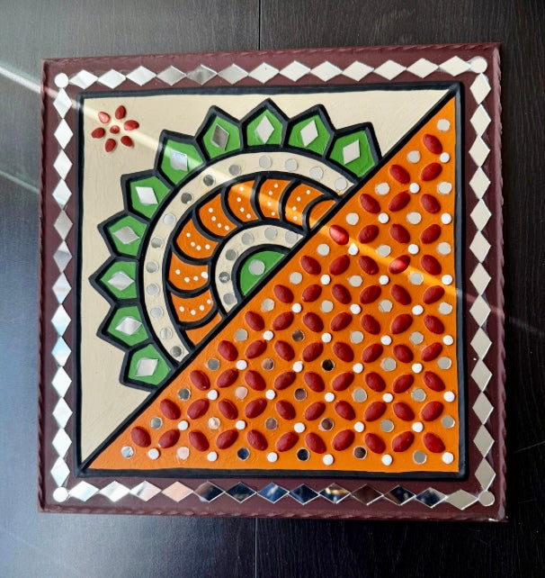 Decorative Lippankaam wall art with geometric pattern on a dark background