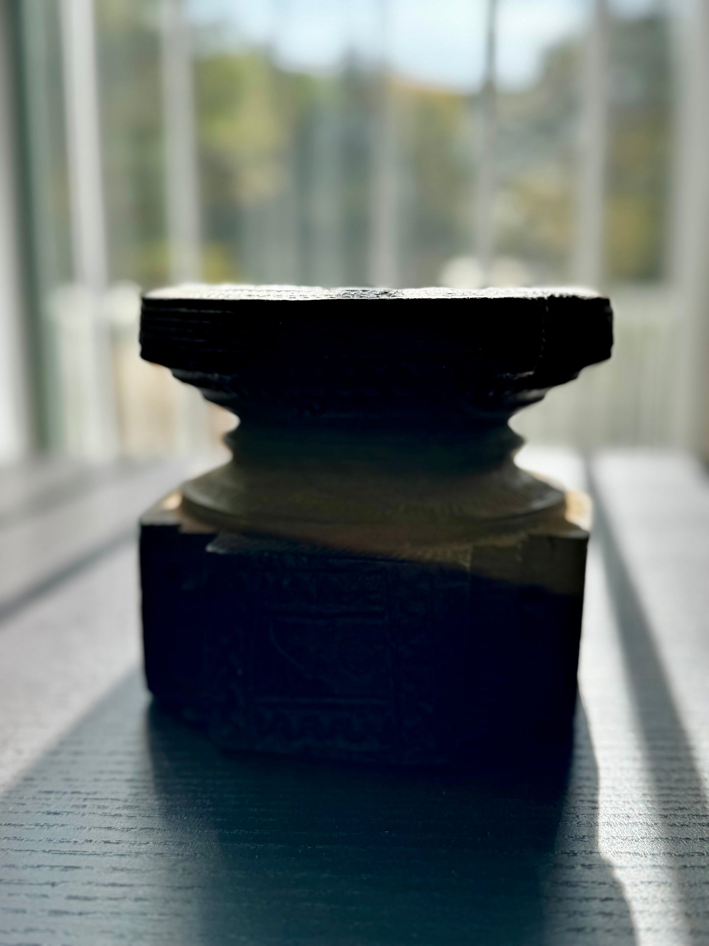 Decorative object on a reflective surface with a blurred background