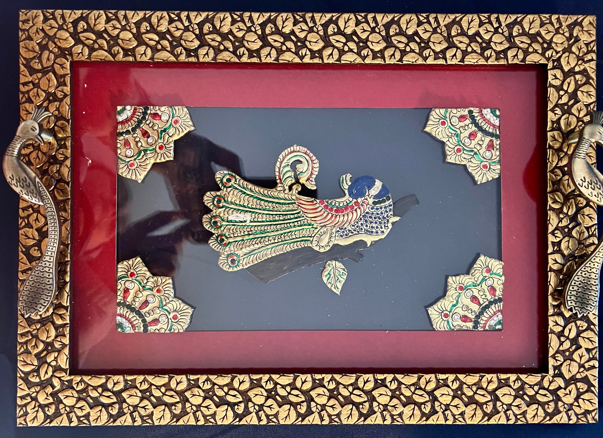 Handcrafted Tanjore work wooden tray featuring intricate gold leaf detailing and vibrant colors, showcasing traditional Indian artistry.