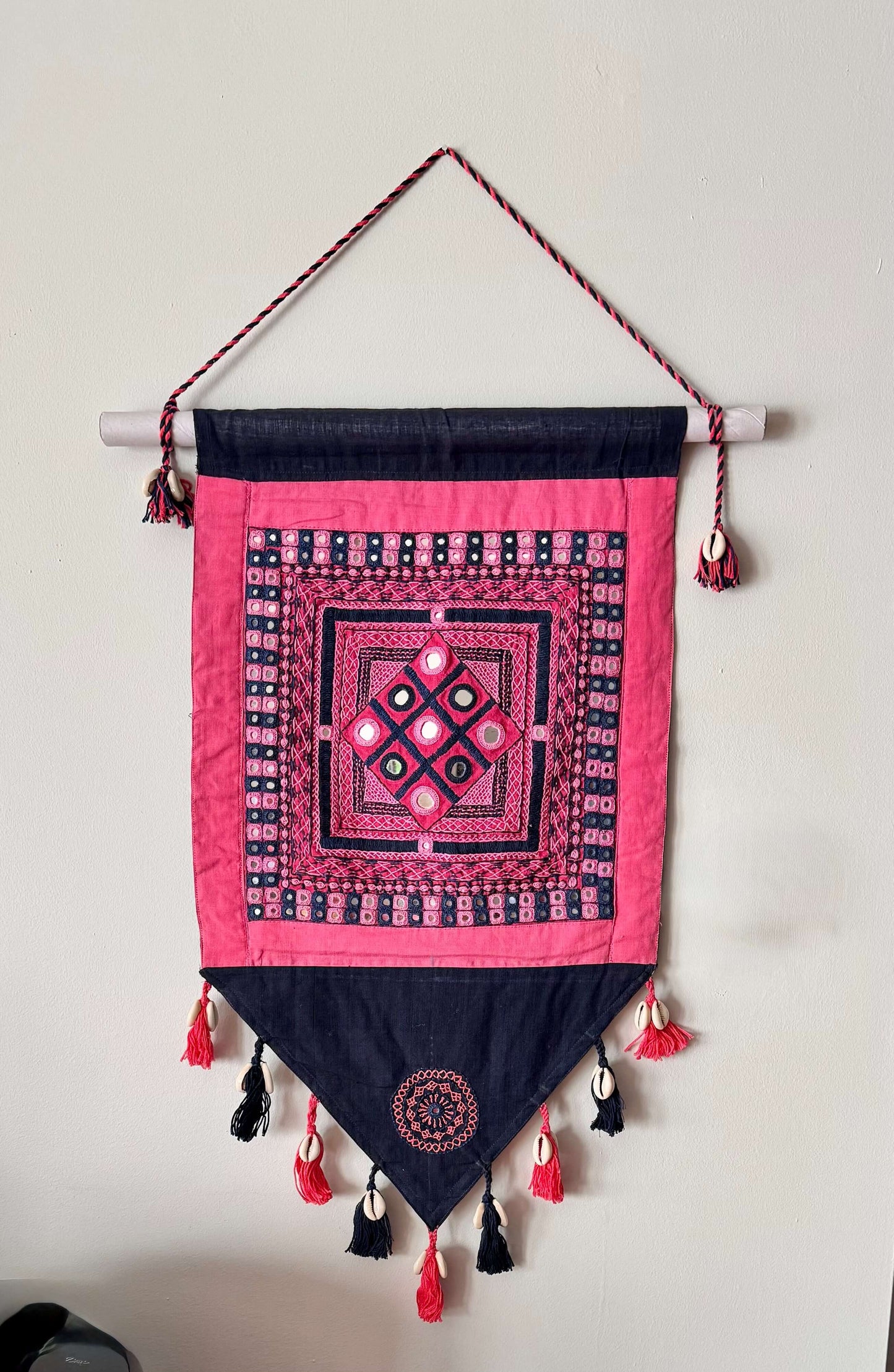 Handcrafted Lambani work textile wall decor, featuring intricate embroidery, mirror work, and vibrant patterns. A stunning display of traditional craftsmanship, adding cultural richness and texture to your space.