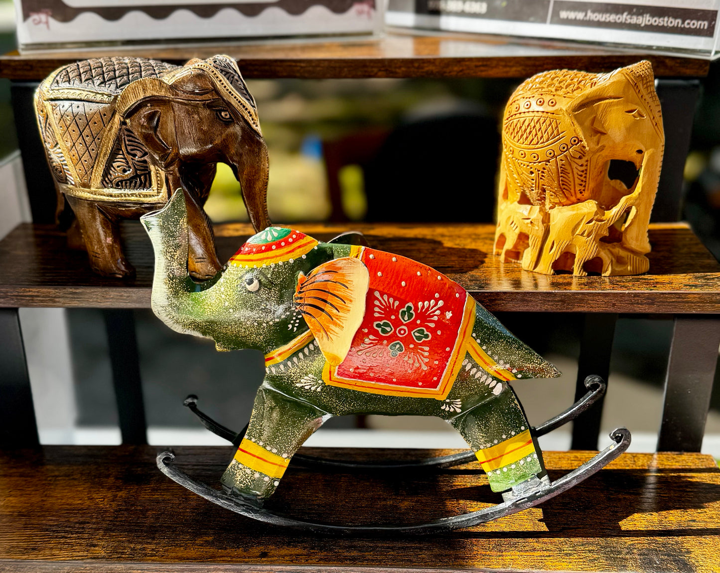 Decorative elephant figurines on a wooden surface