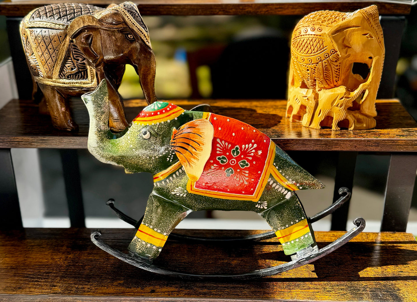 Decorative elephant figurines on a wooden surface