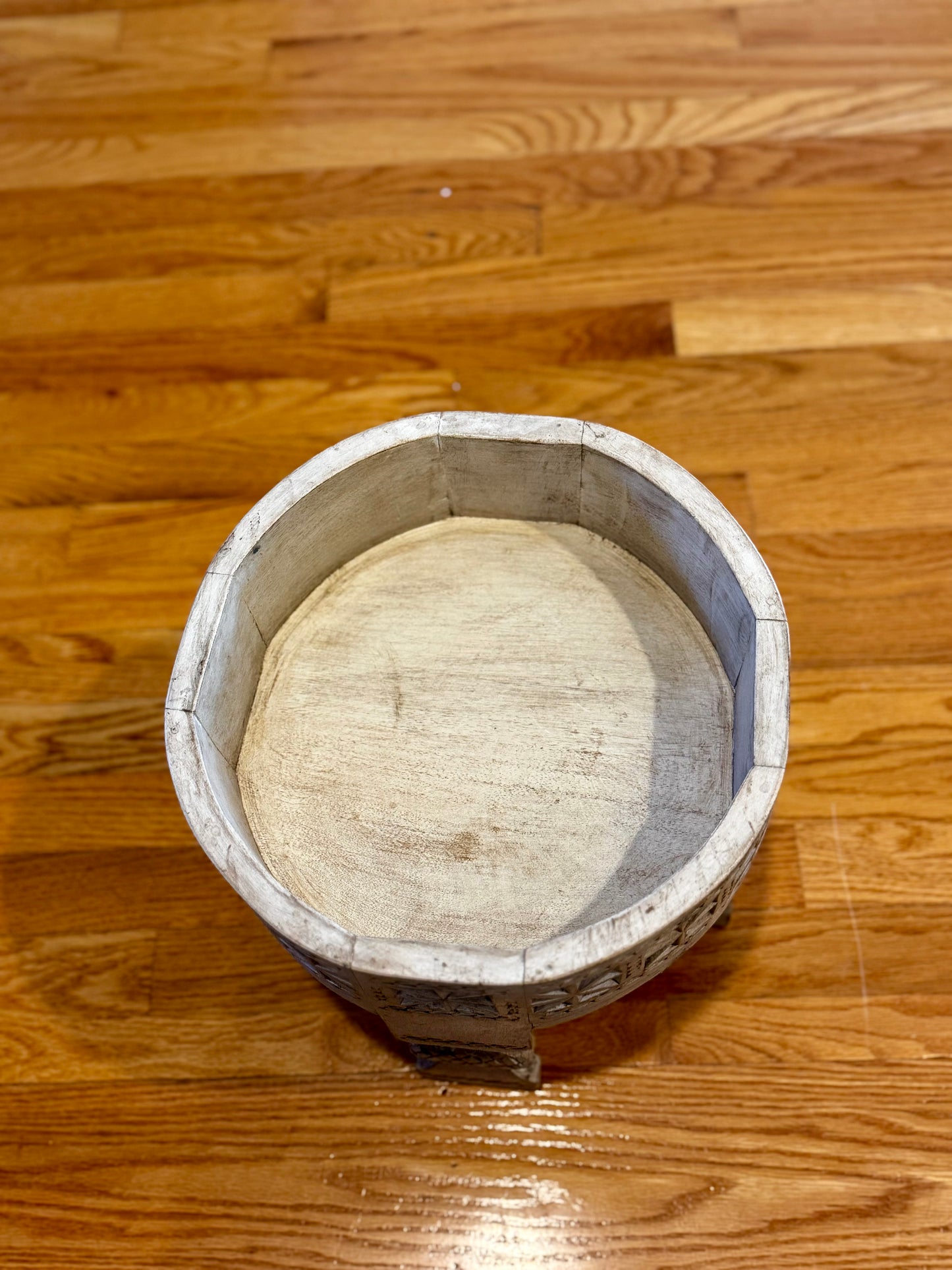 Round wooden stool on a wooden floor