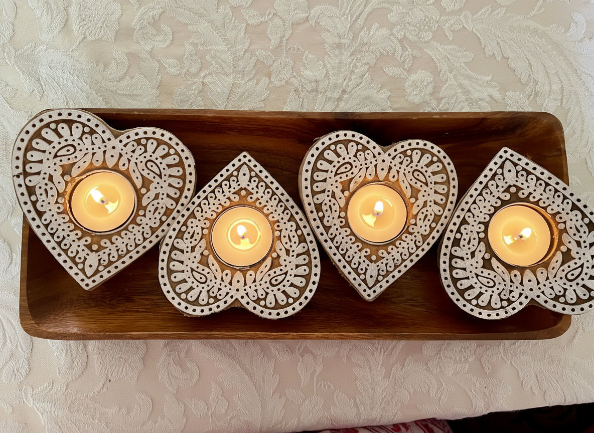 Hand-carved wooden tea light holders in various shapes, featuring intricate designs and natural finishes, adding a rustic, artisanal touch to your home decor.