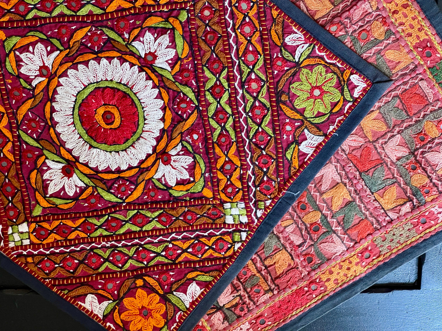 Rann - Threads of Kutch showcasing intricate Kutchi embroidery patterns and vibrant colors on textile pieces.