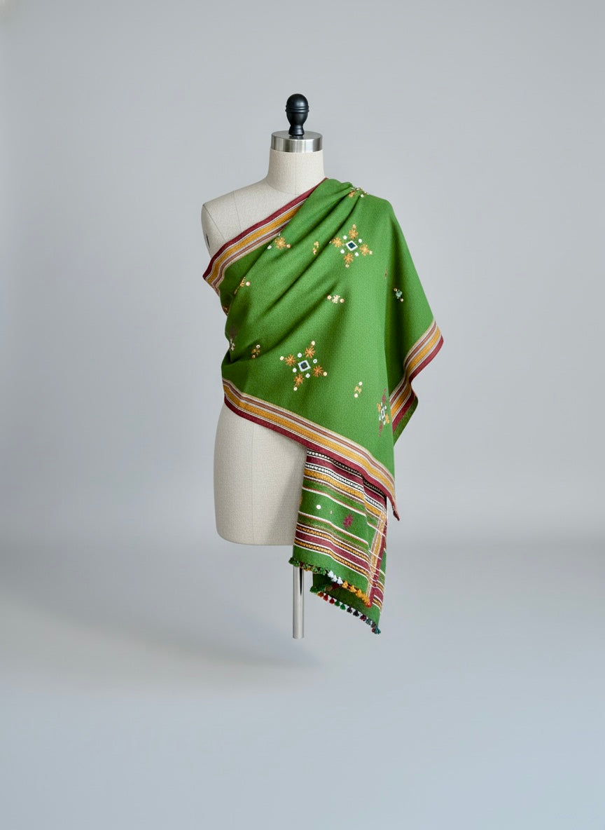 Green woolen shawl draped on a mannequin 