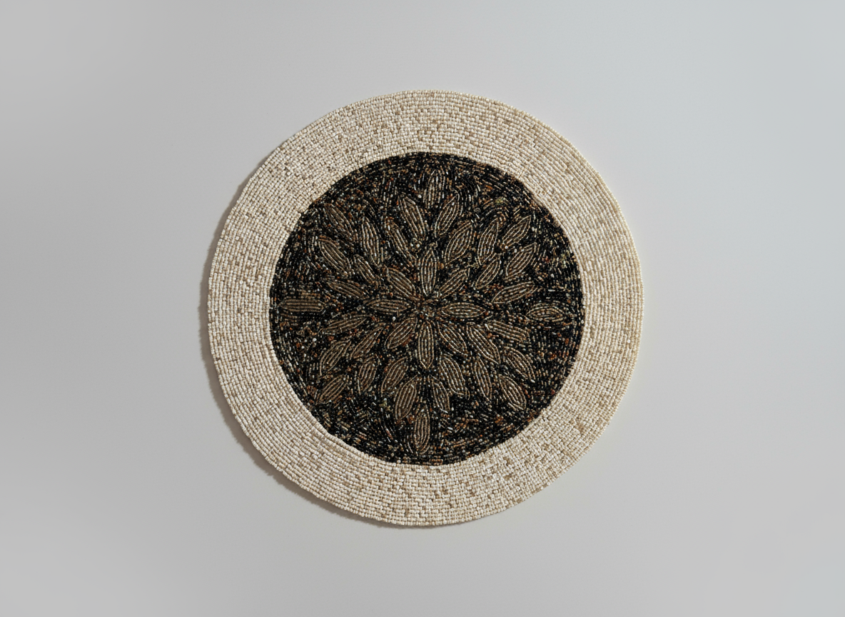 Round woven placemat with black center design on a gray background