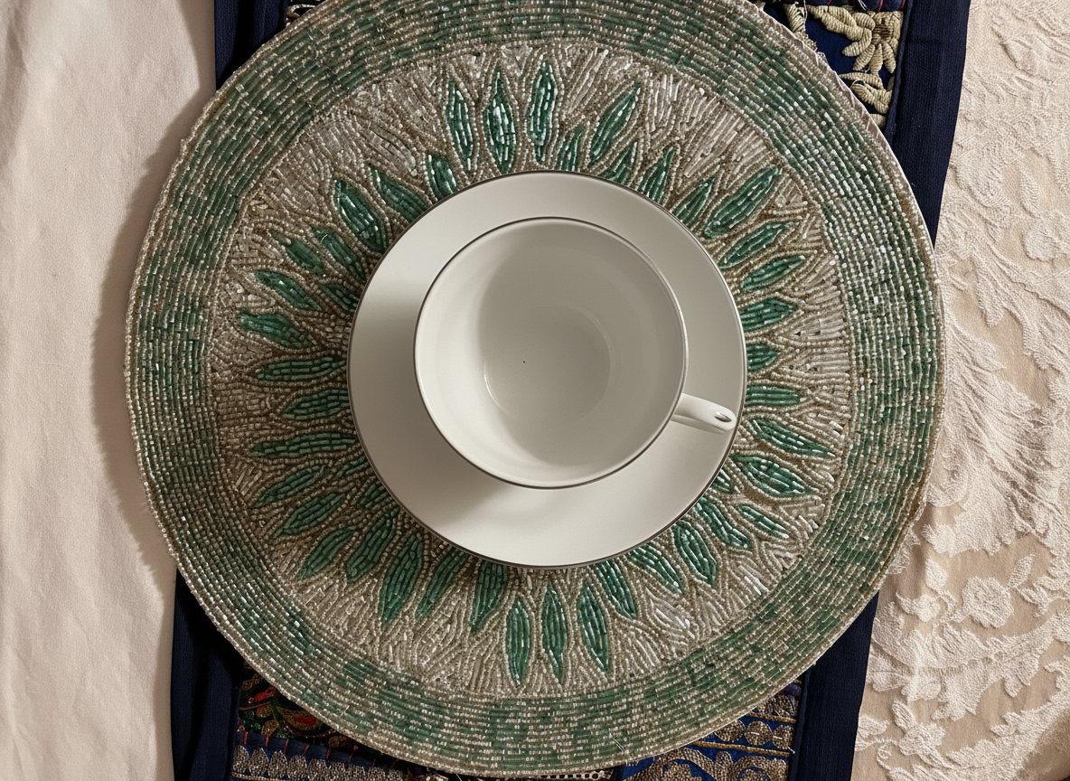 White teacup and saucer on a decorative green and gold plate with a textured background