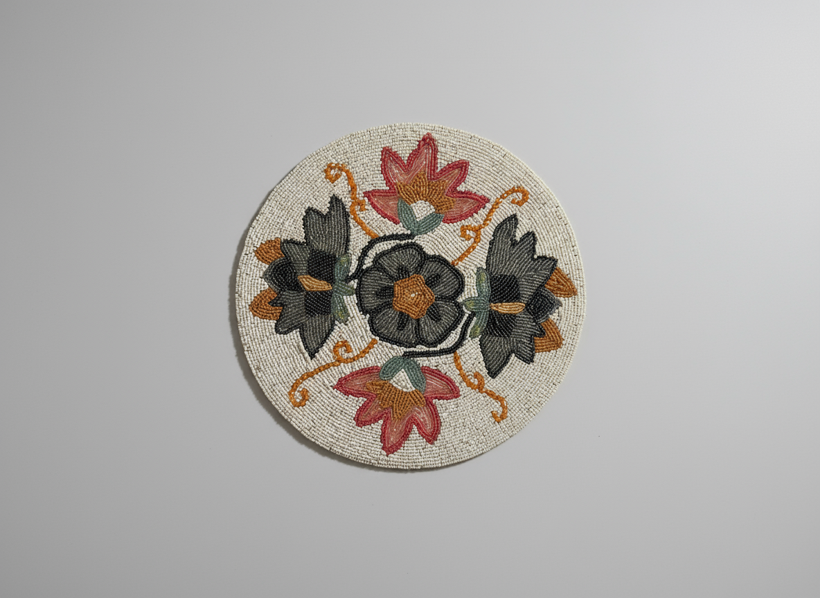 Circular embroidered patch with floral design on a gray background