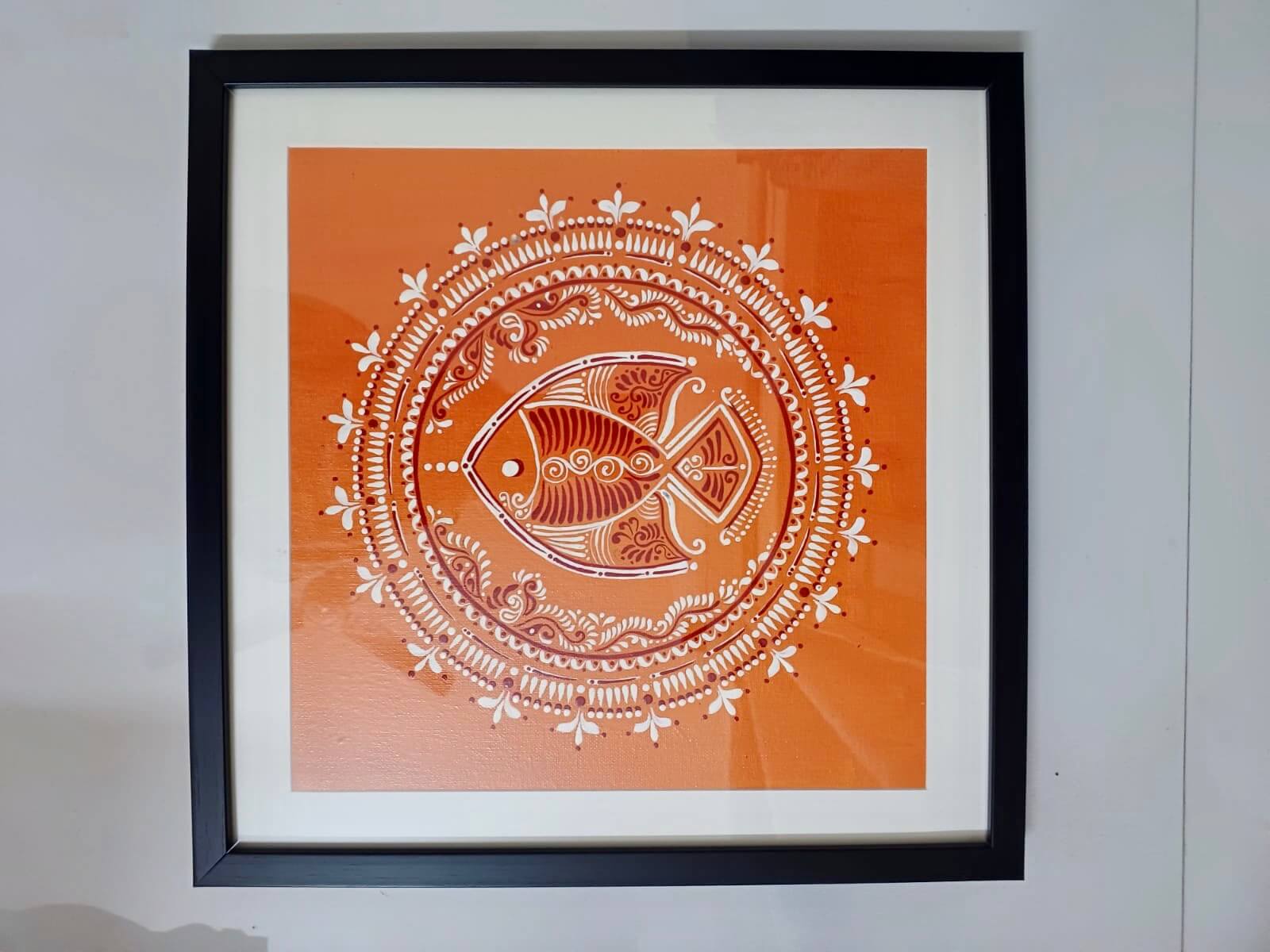 Handcrafted Alpona art wall decor featuring intricate, traditional Bengali motifs in elegant, flowing patterns.